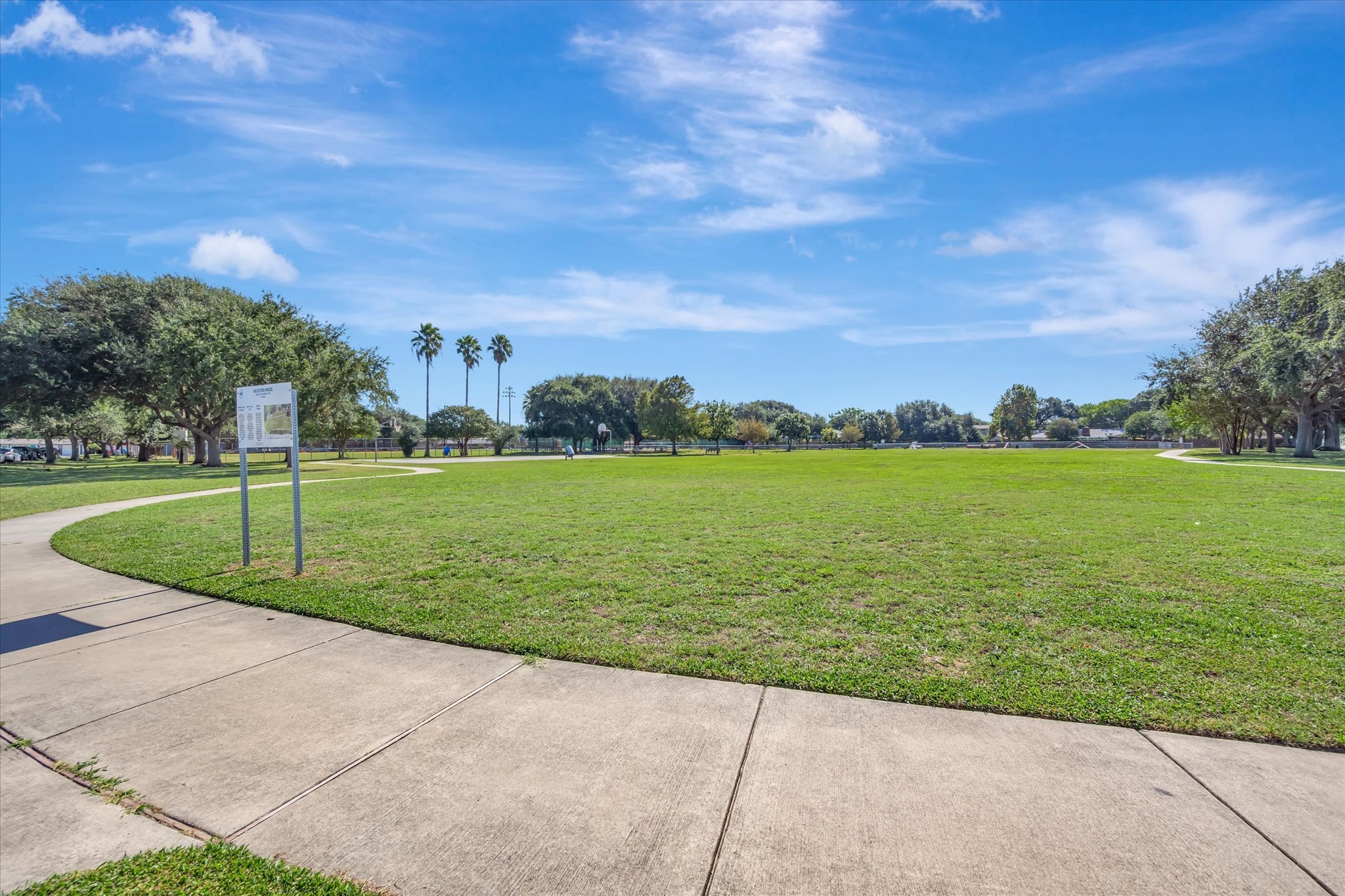 Additional view of the communitys open lawn and paved walkways.