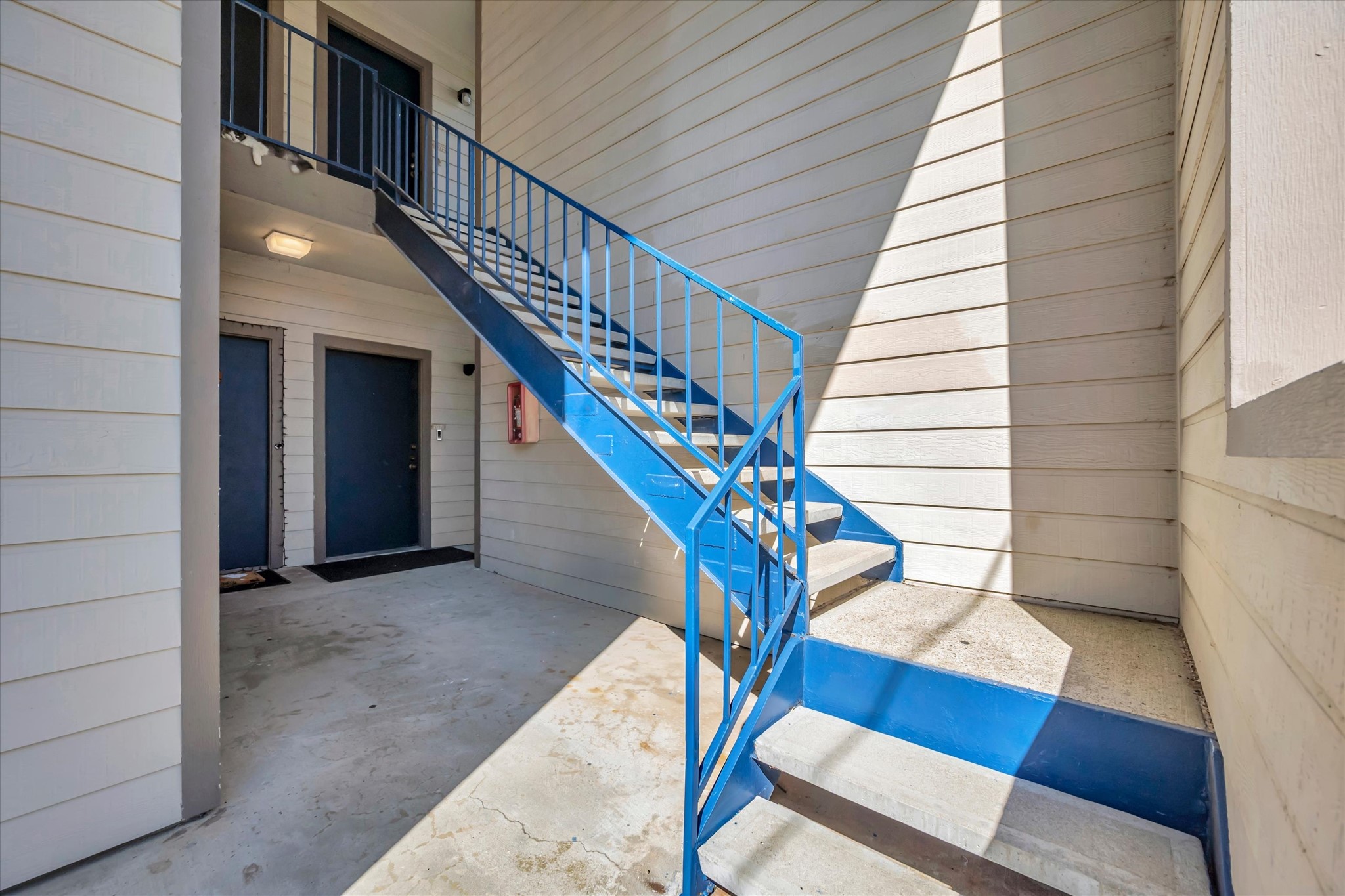 Exterior stairway and walkway serving the condominium building.