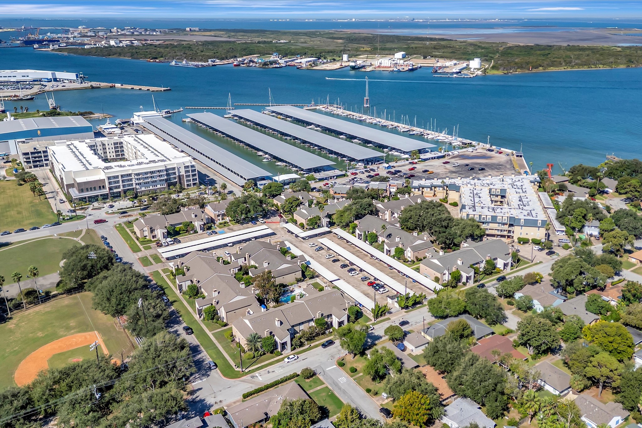 Aerial view of the surrounding area, including nearby marina facilities and waterways.