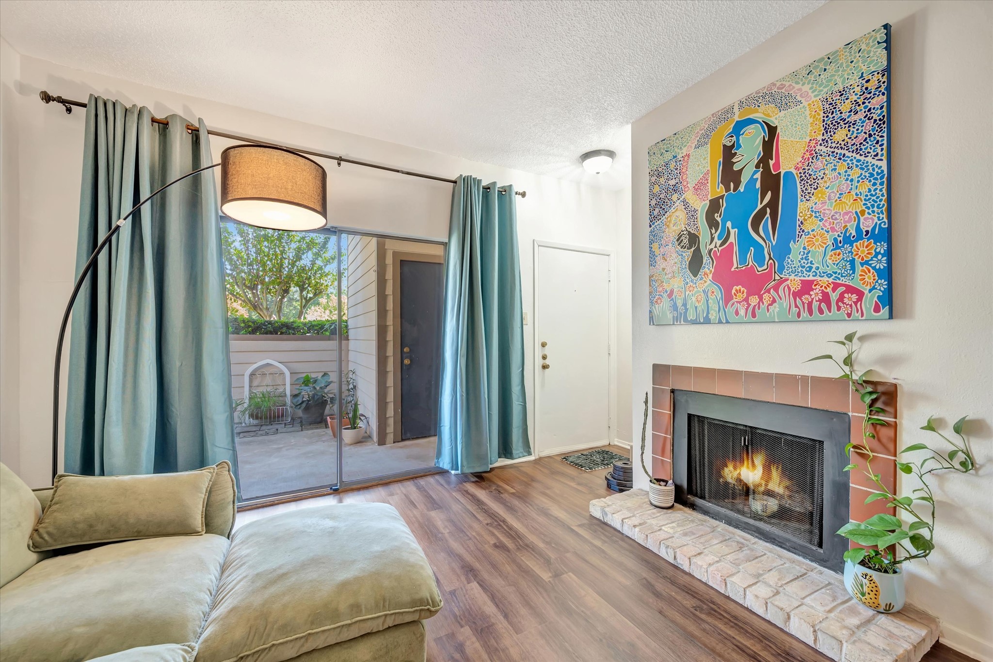 Fireplace adds a cozy focal point to the living area, with patio access nearby.