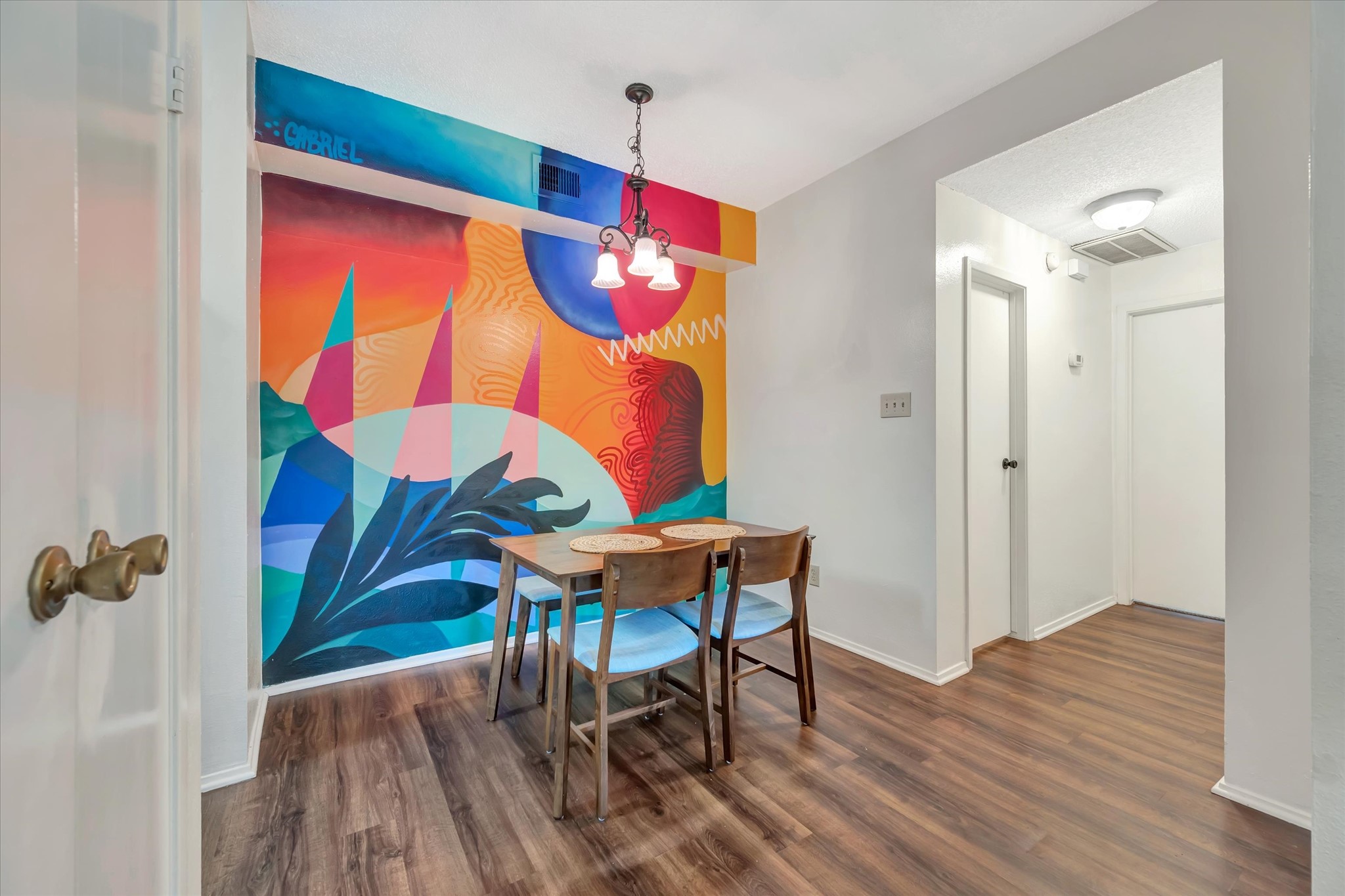 Custom mural creates a distinctive backdrop for the dining area.