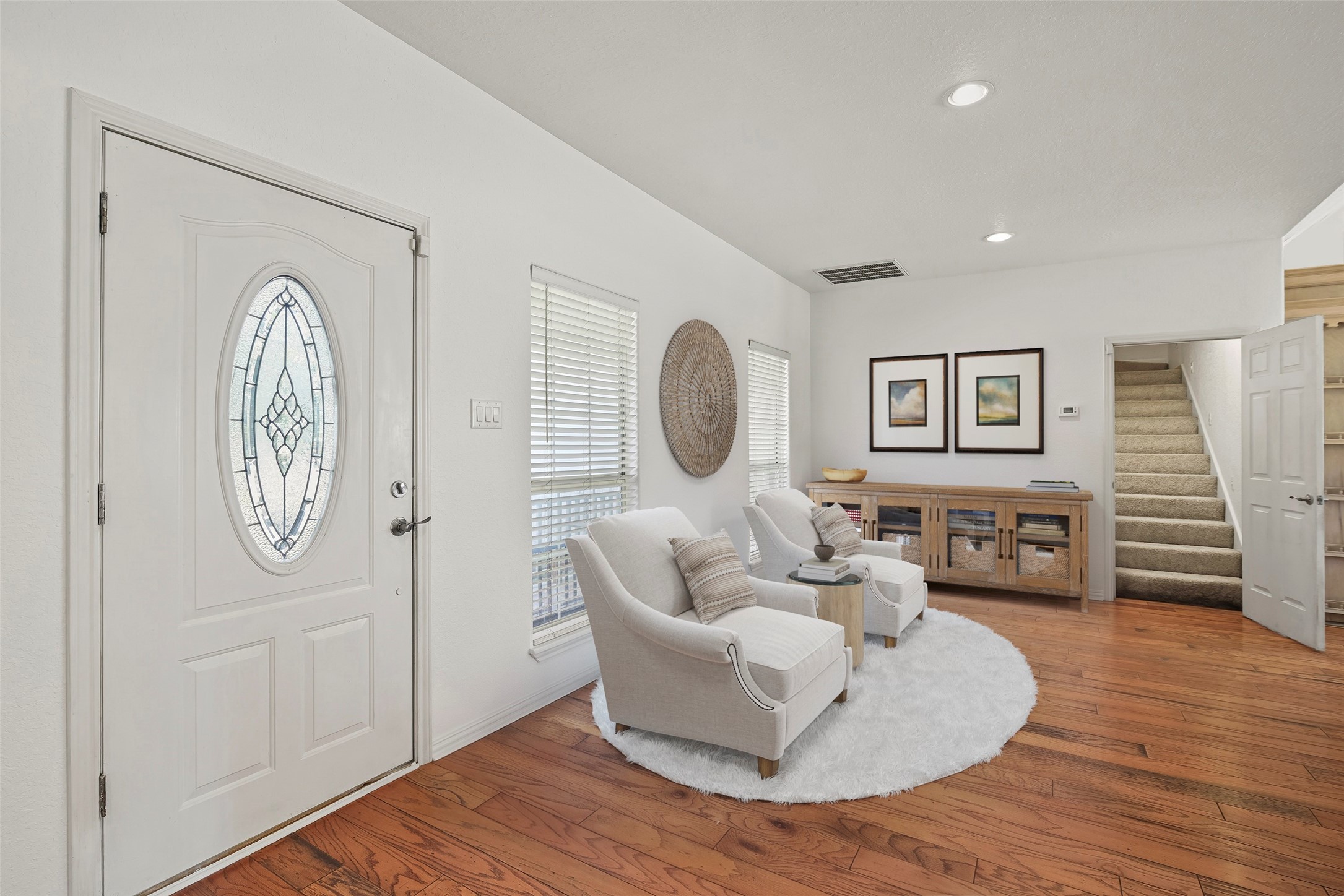 Front entry of home showcases beautiful hardwood floors and opens into the family room. **Virtually Staged**