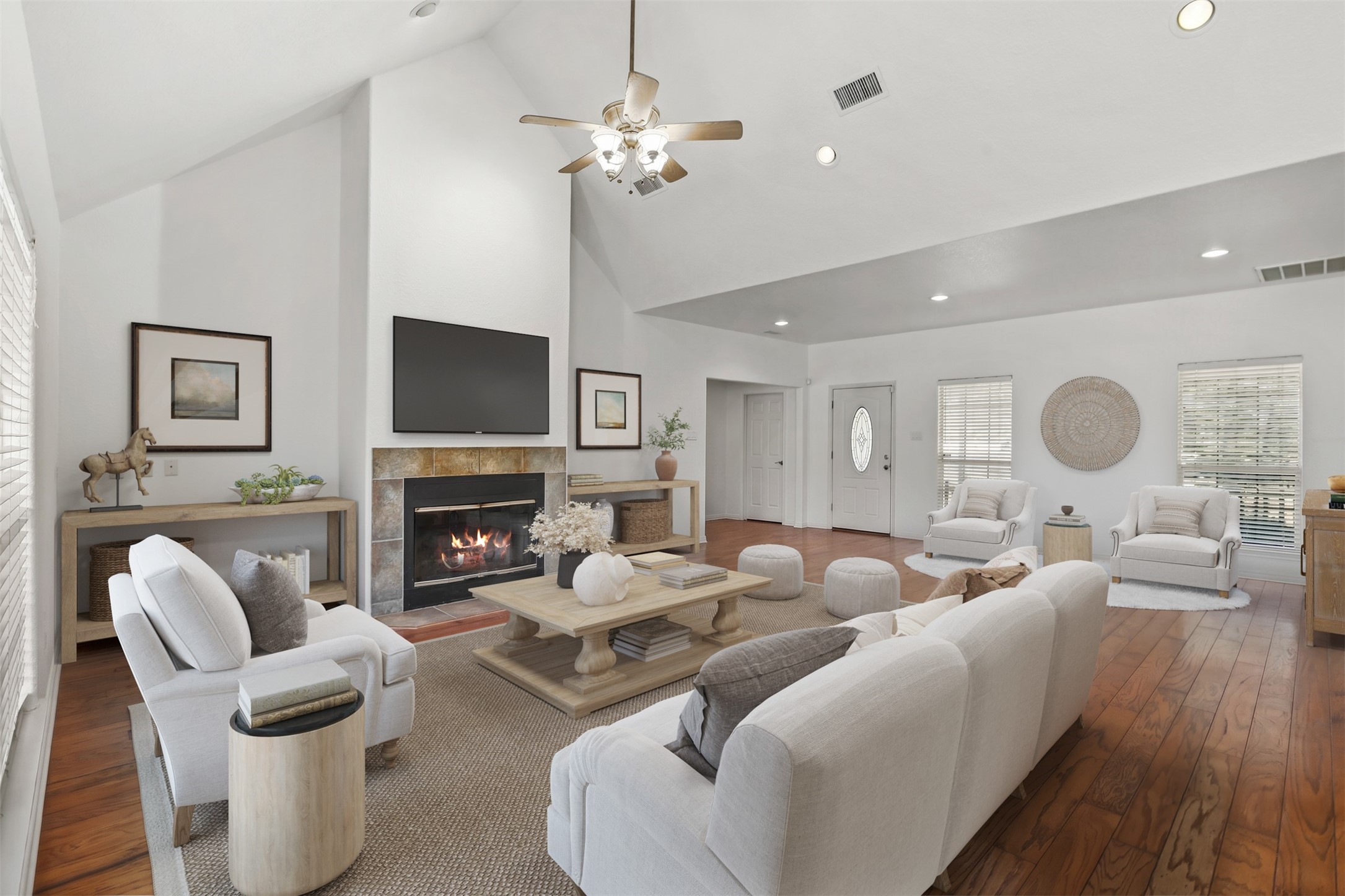 The spacious family room features hardwood floors, architectural ceiling, fan and wood burning fireplace with tile surround. **Virtually Staged**