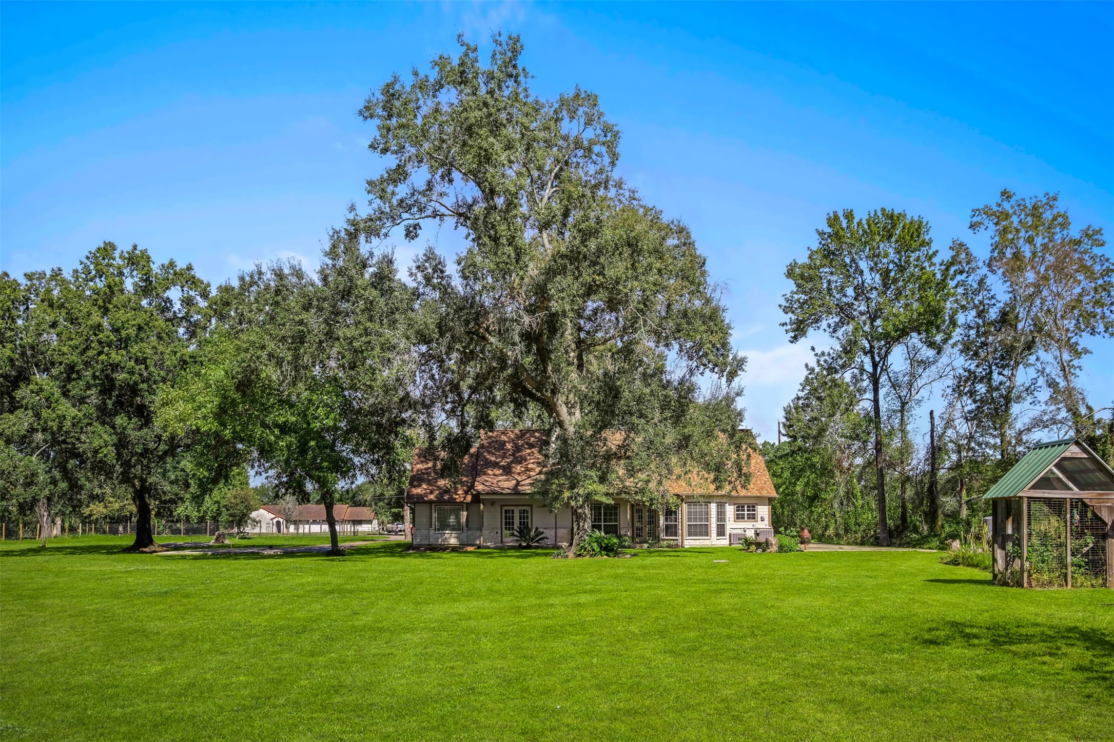 View of the back elevation of the home. The home features a septic system. New submersible pump and floats installed in 2026 and the alarm system was rebuilt. **Grass virtually enhanced**