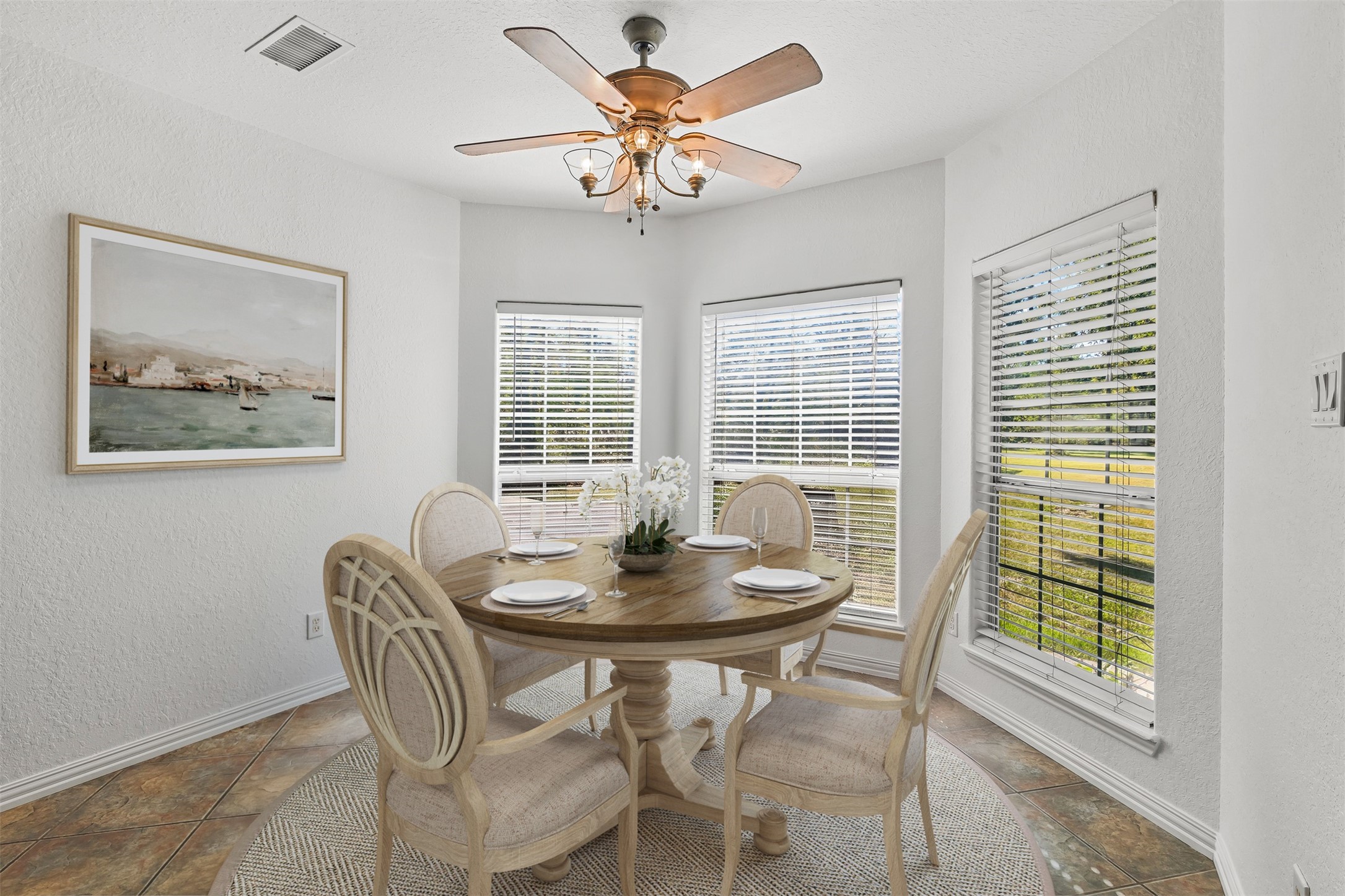The breakfast room has tile floors, ceiling fan and large bay window overlooking he peaceful backyard. The breakfast room was recently painted. **Virtually Staged**