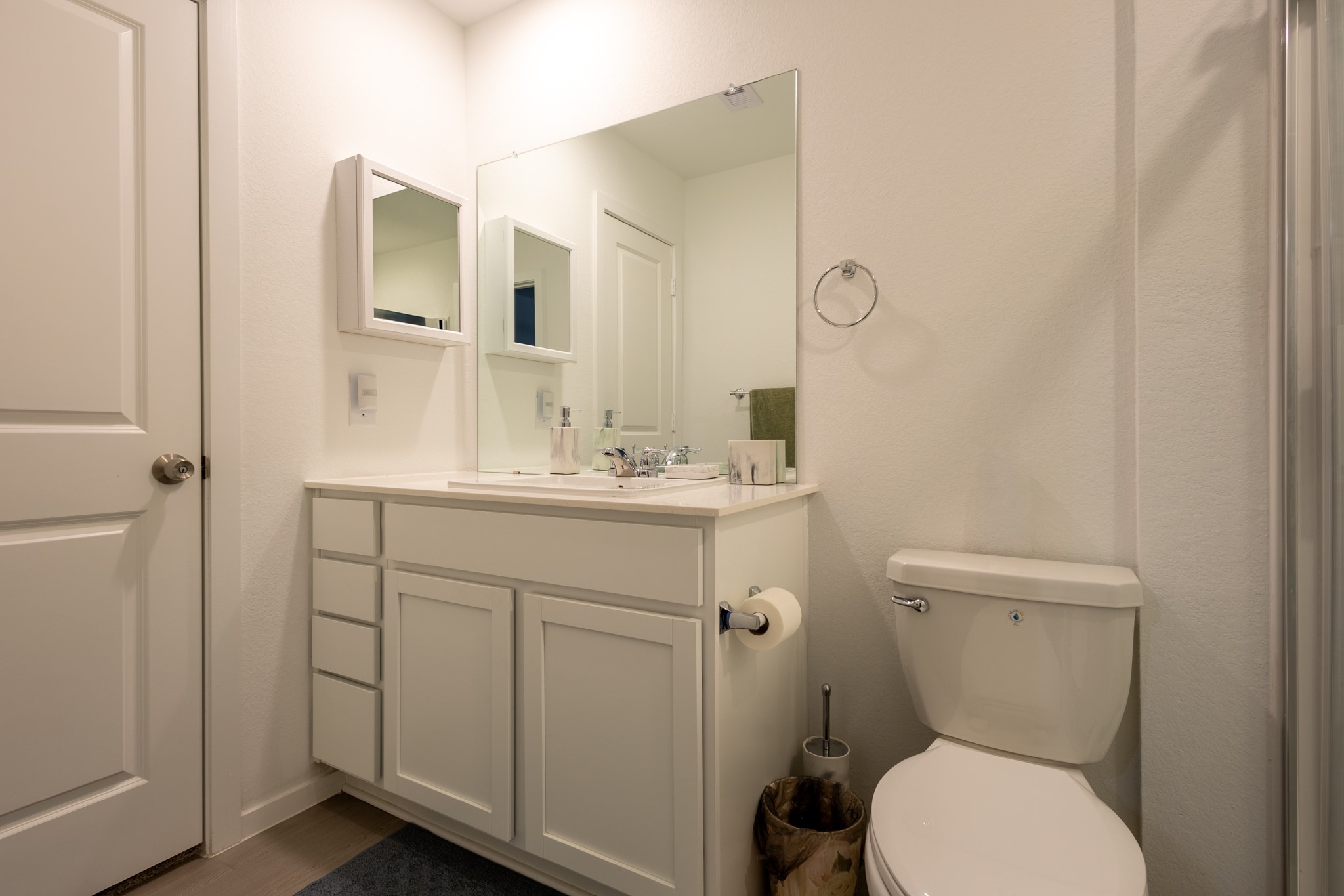 A spa-like primary bathroom retreat equipped with a spacious vanity, clean fixtures, and a bright, refreshing design.