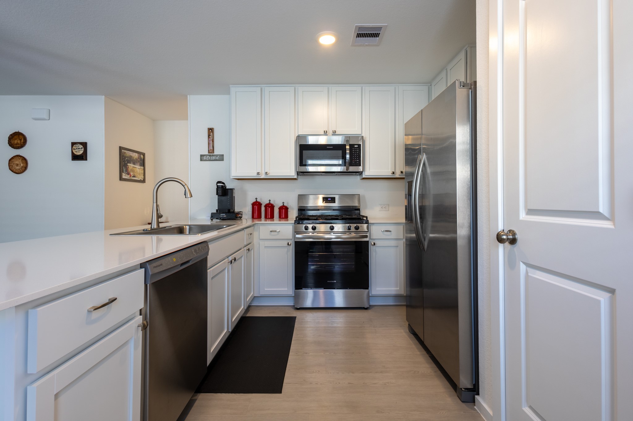 A chefs delight! The open kitchen layout boasts sleek cabinetry, premium stainless-steel appliances, and an abundance of counter space.