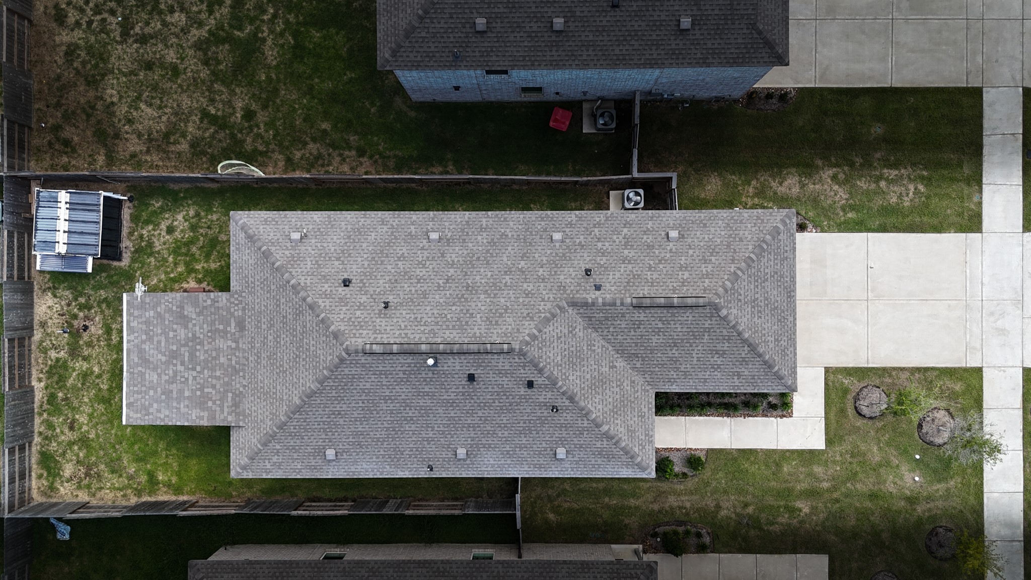 A spectacular bird's-eye view showcasing the vast perimeter of the lot, your custom patio, and the included bonus storage shed!