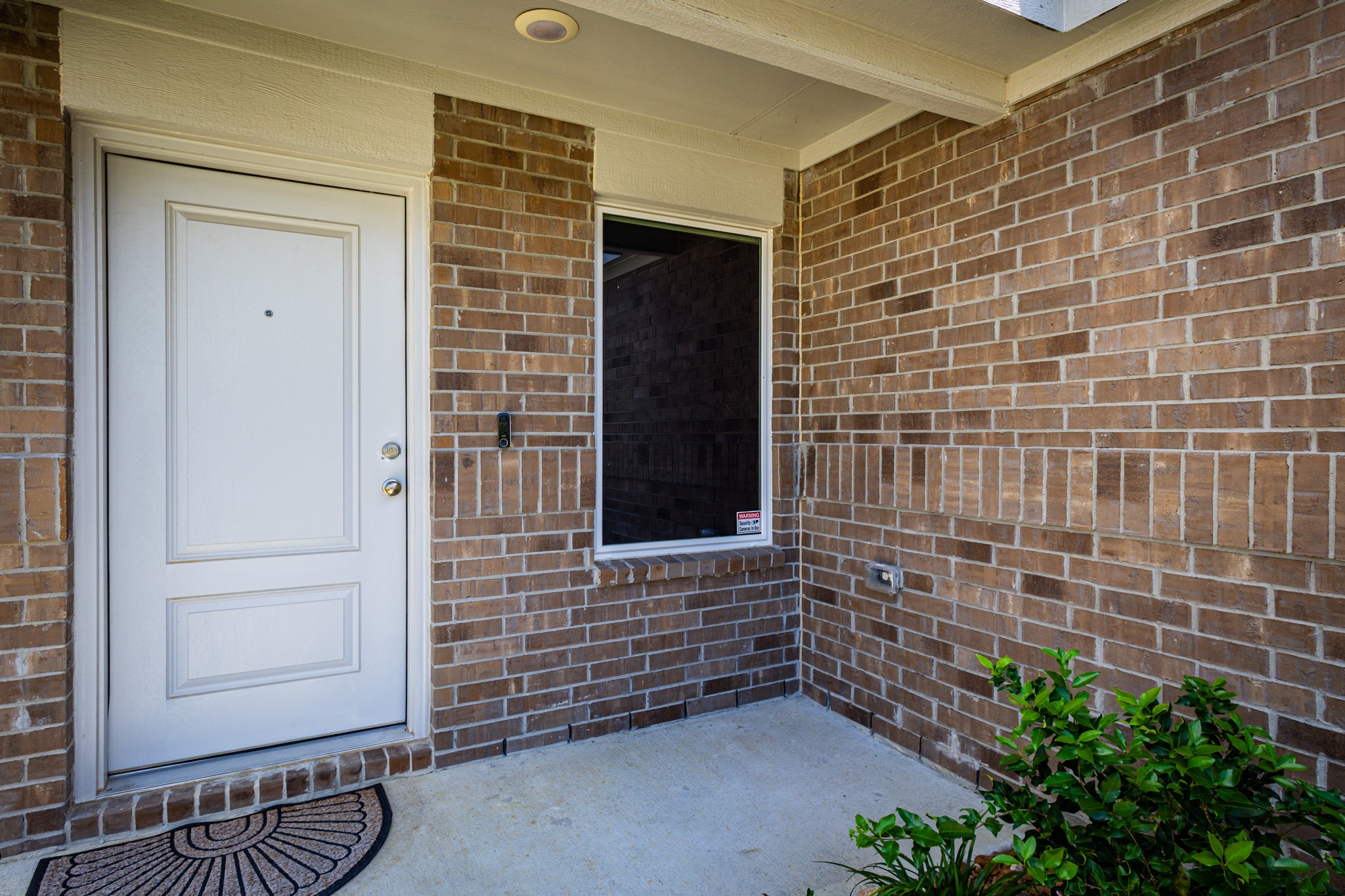 Stepping into your future home! The bright front entrance features a classic glass-paneled door that fills the foyer with warm, natural sunlight.