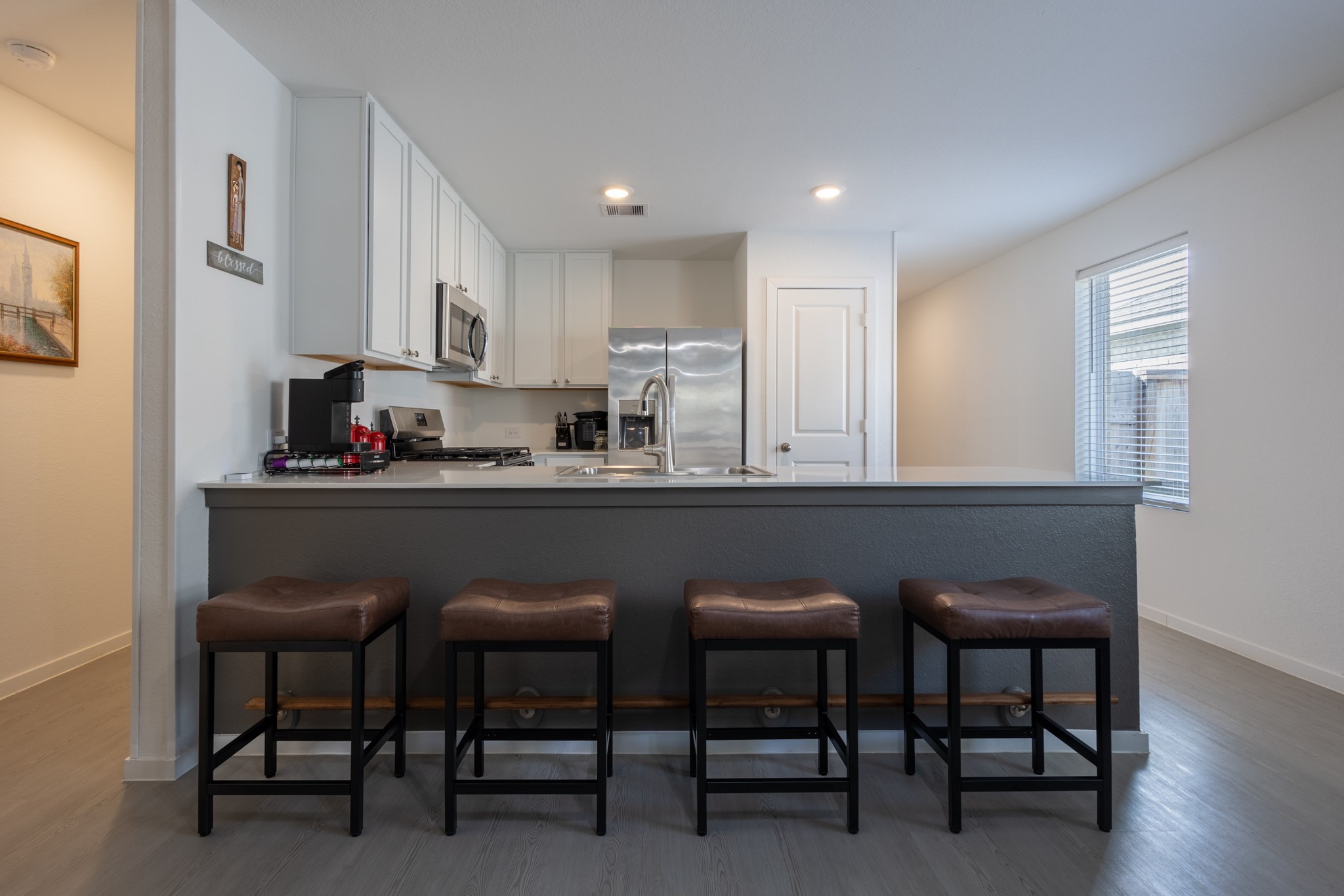 Incredible open-sight lines! The kitchen looks directly over the main living spaces, ensuring you are always part of the conversation while cooking.
