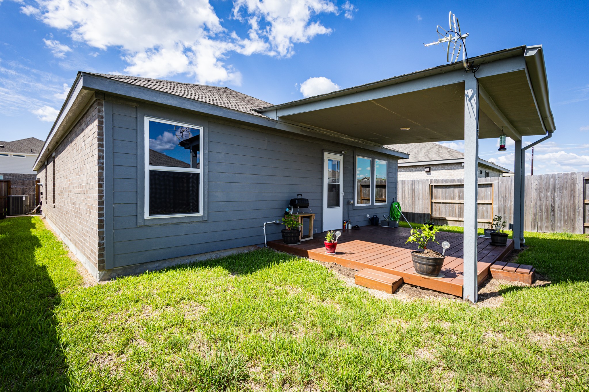 The ideal spot for outdoor grilling, dining, or morning coffee while looking out over your expansive lawn.