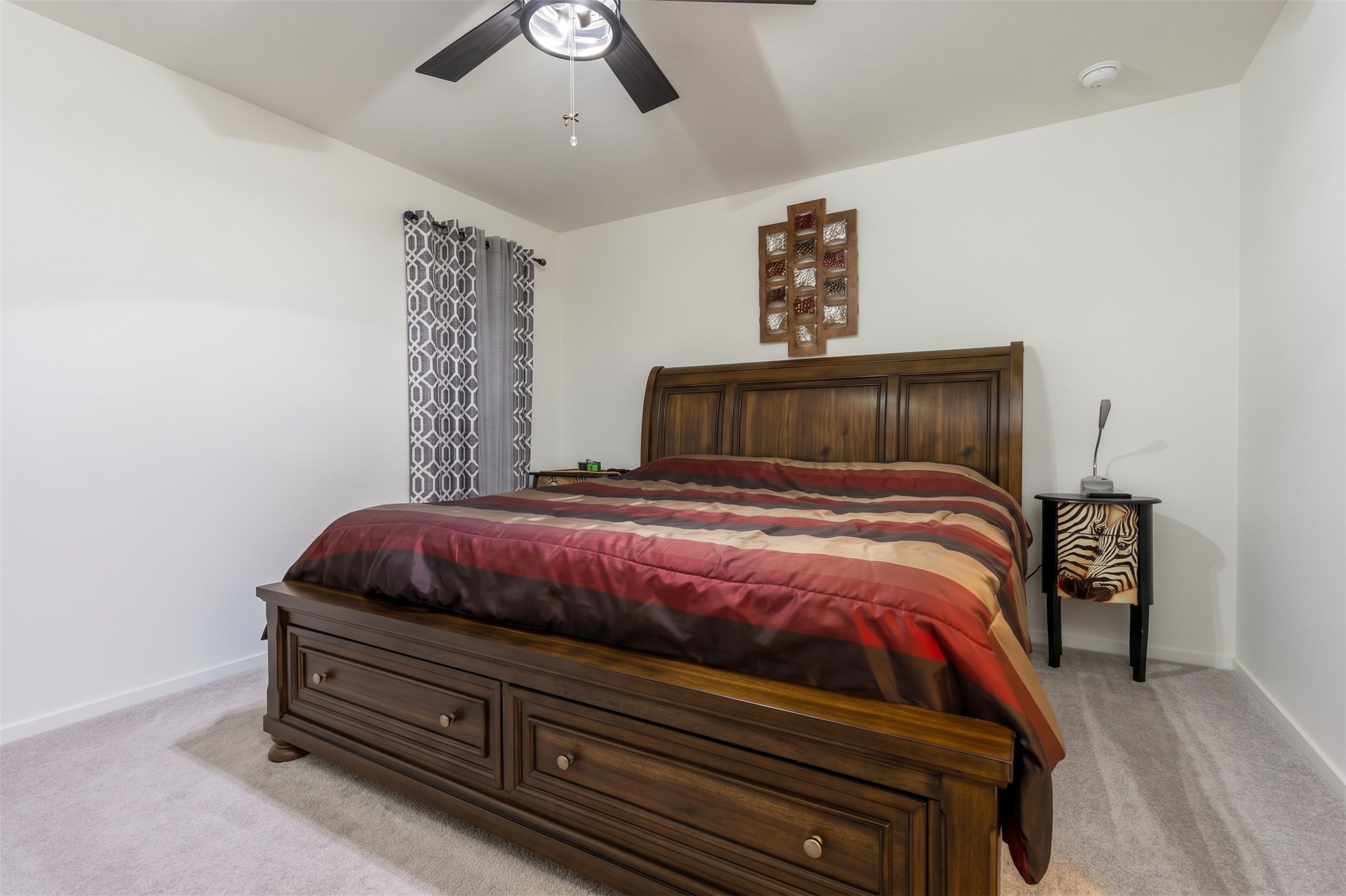 Another view of the generous primary bedroom, showing off the ample square footage and the serene color palette.