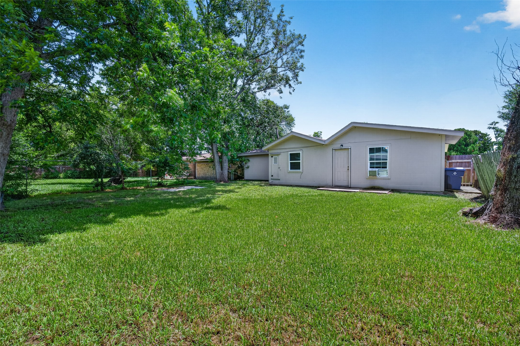 Charming single-story home with a spacious backyard, shaded by mature trees. Ideal for outdoor activities and relaxation.