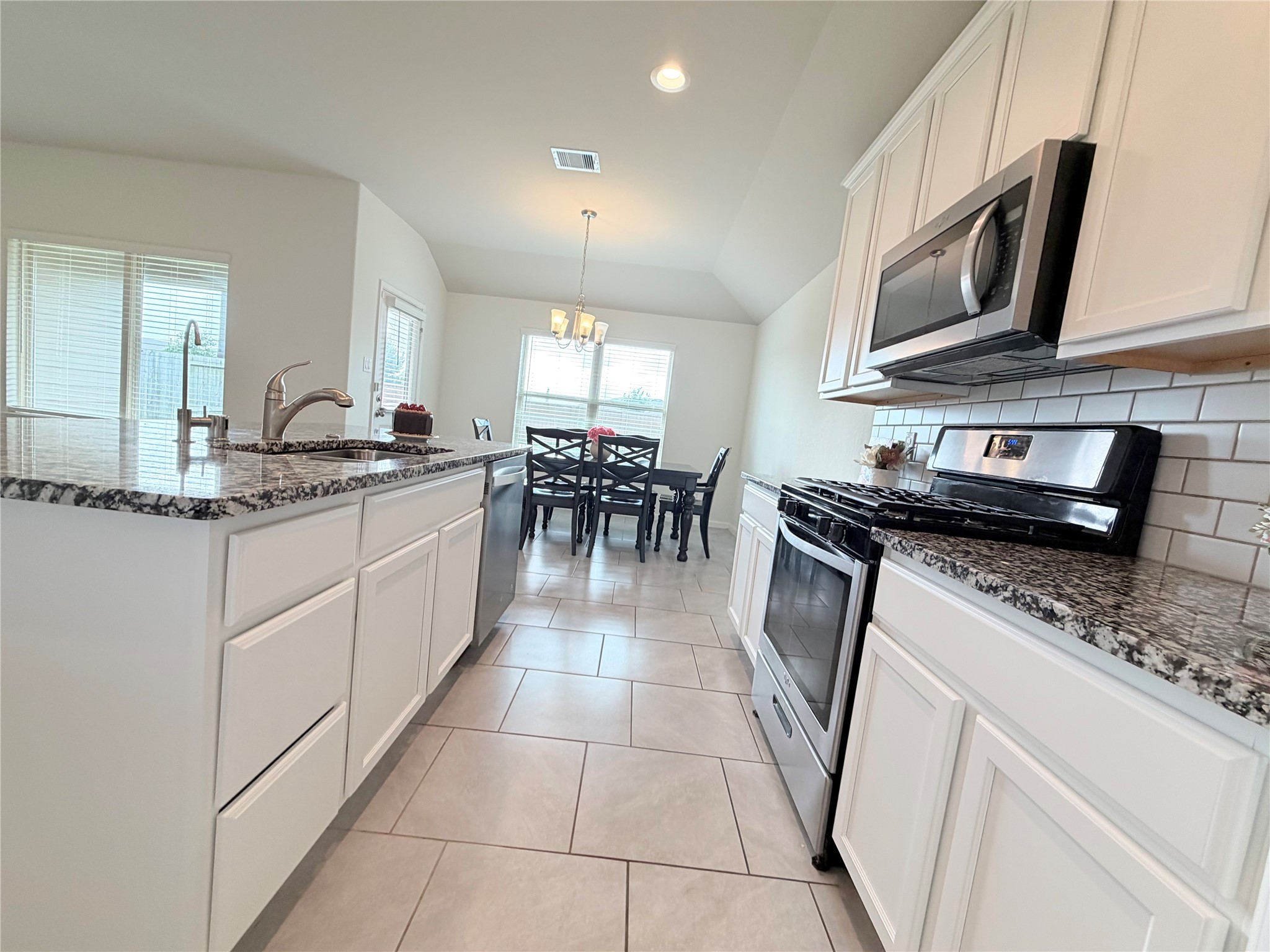 Professionally painted white cabinetry brightens the kitchen and creates a fresh, modern feel.