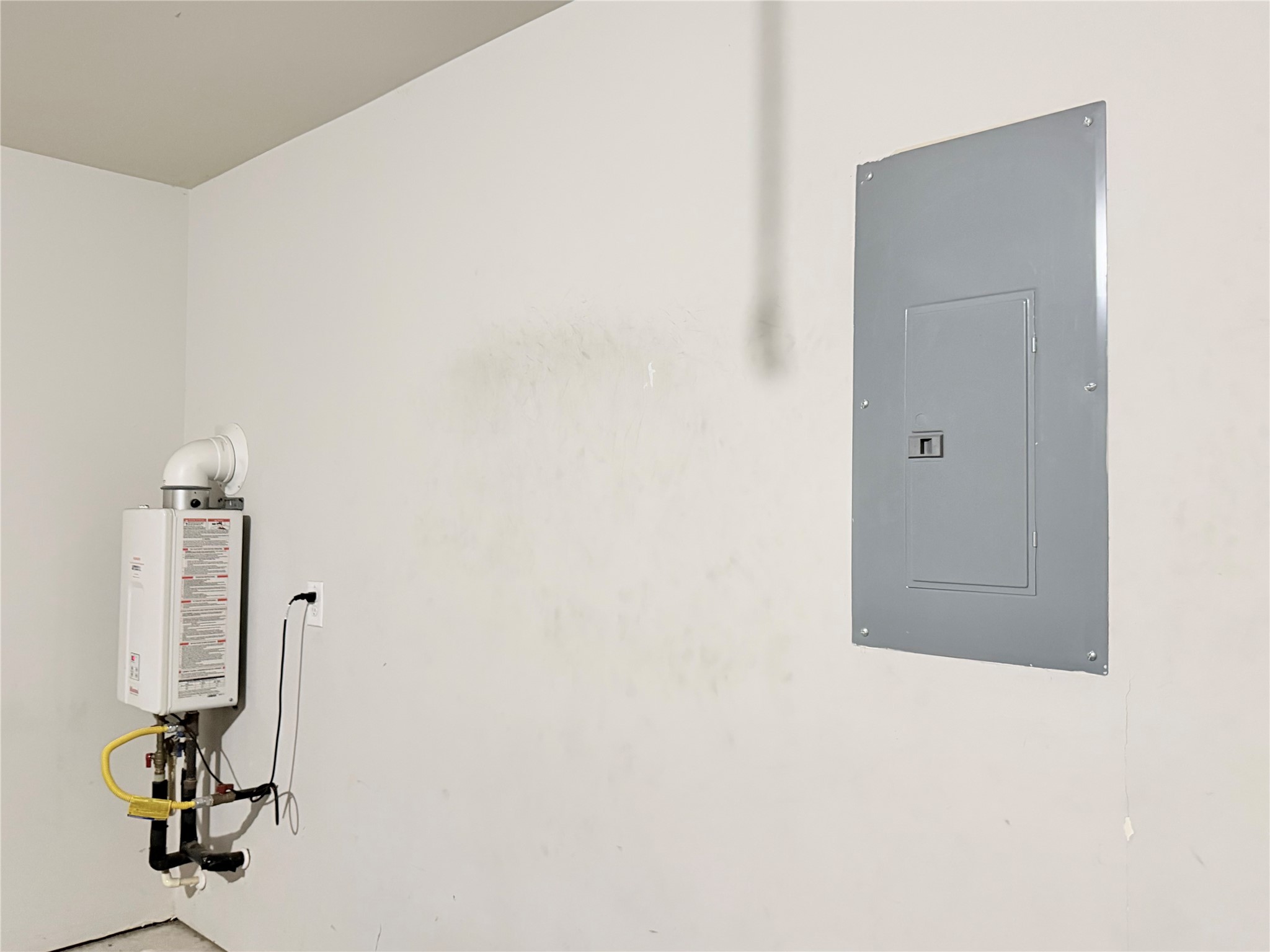 Tankless Water Heater and Electric Panel are inside the garage.