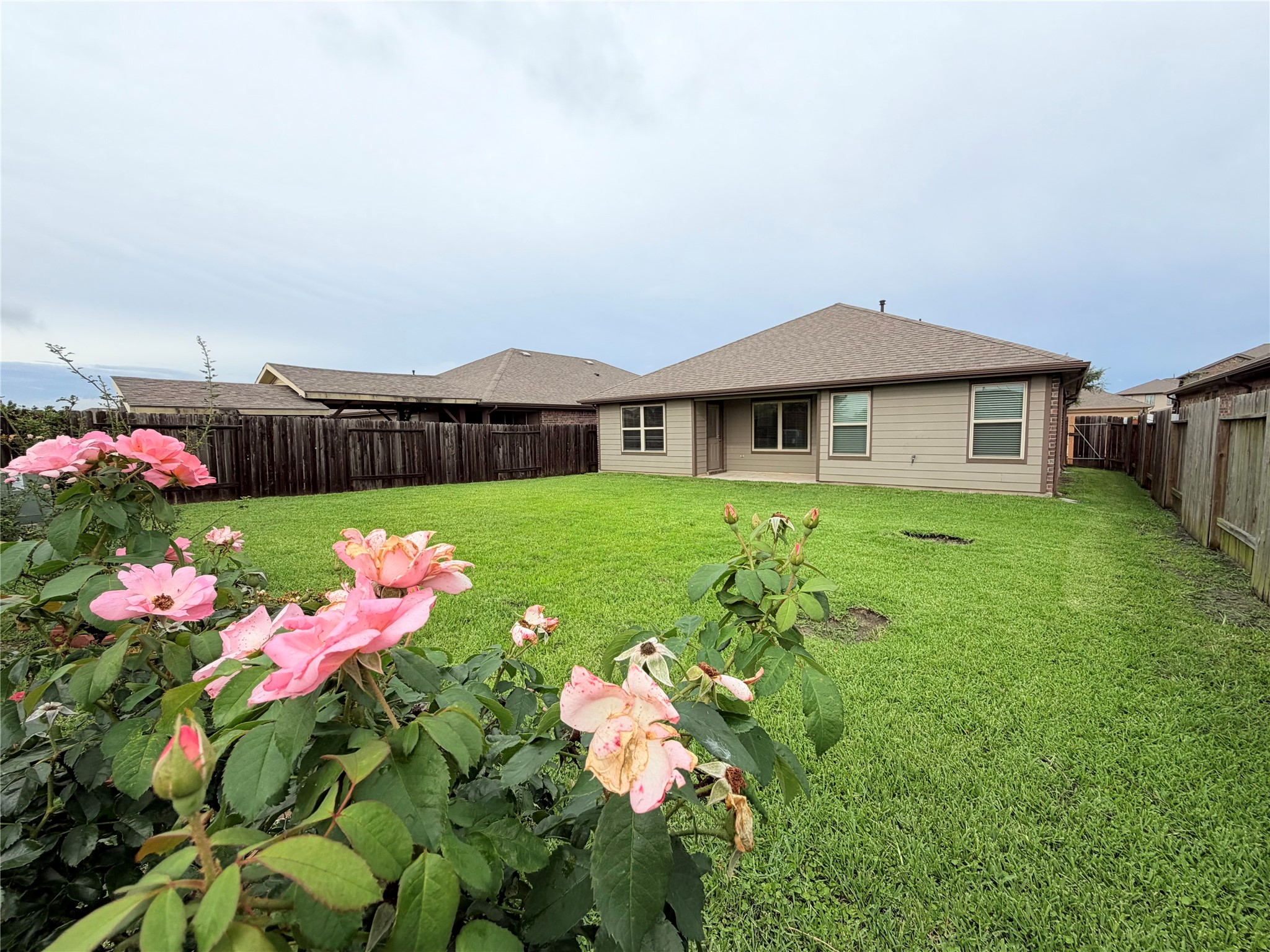Beautiful rose garden welcomes you to an oversized backyard offer ample space for outdoor entertaining.