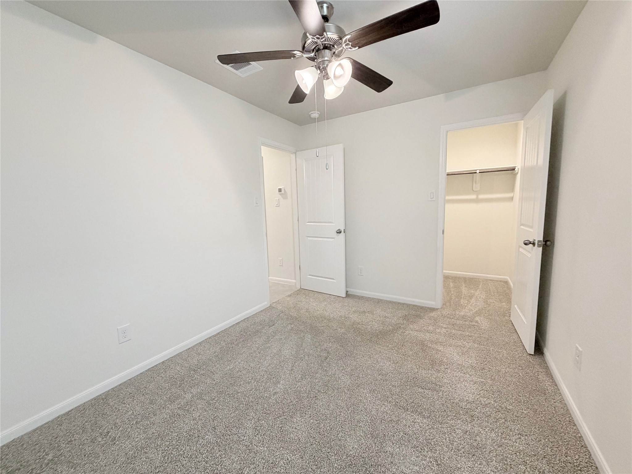 Bedroom 3 has a ceiling fan and a walk in closet.