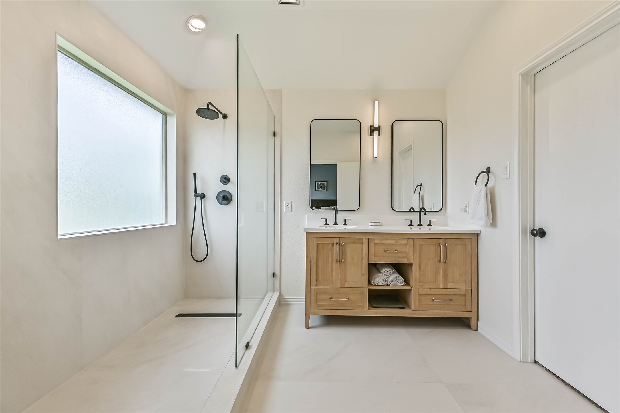 A view of the oversized completely renovated primary bathroom.