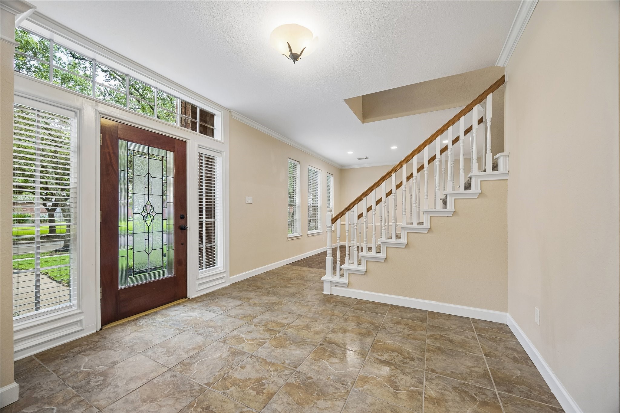 One inside, you step into this large foyer.  Straight ahead past the stairs is the large dining room, which then goes to the kitchen.  Behind is the office/study.