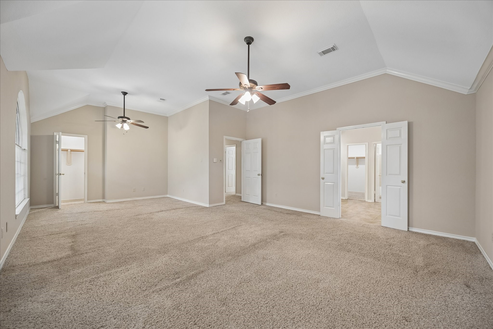 And one more view of the primary bedroom.  Through the double doors is the primary spa-like bathroom.