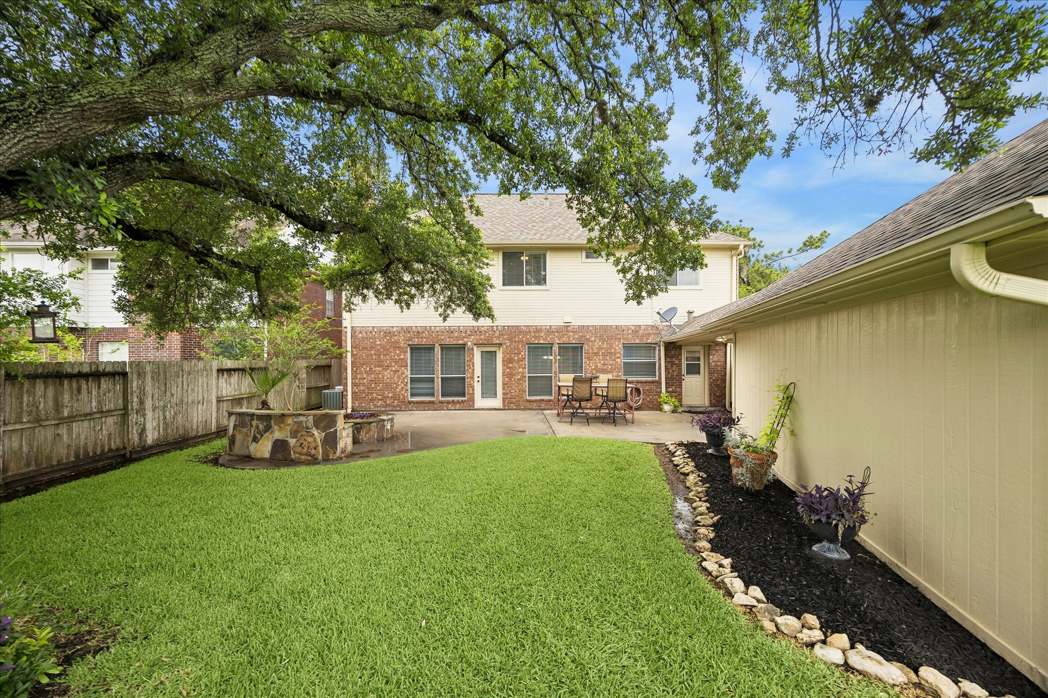 The gorgeous oak tree provides a lot of shade in the backyard.  The grass is so green and vibrant.