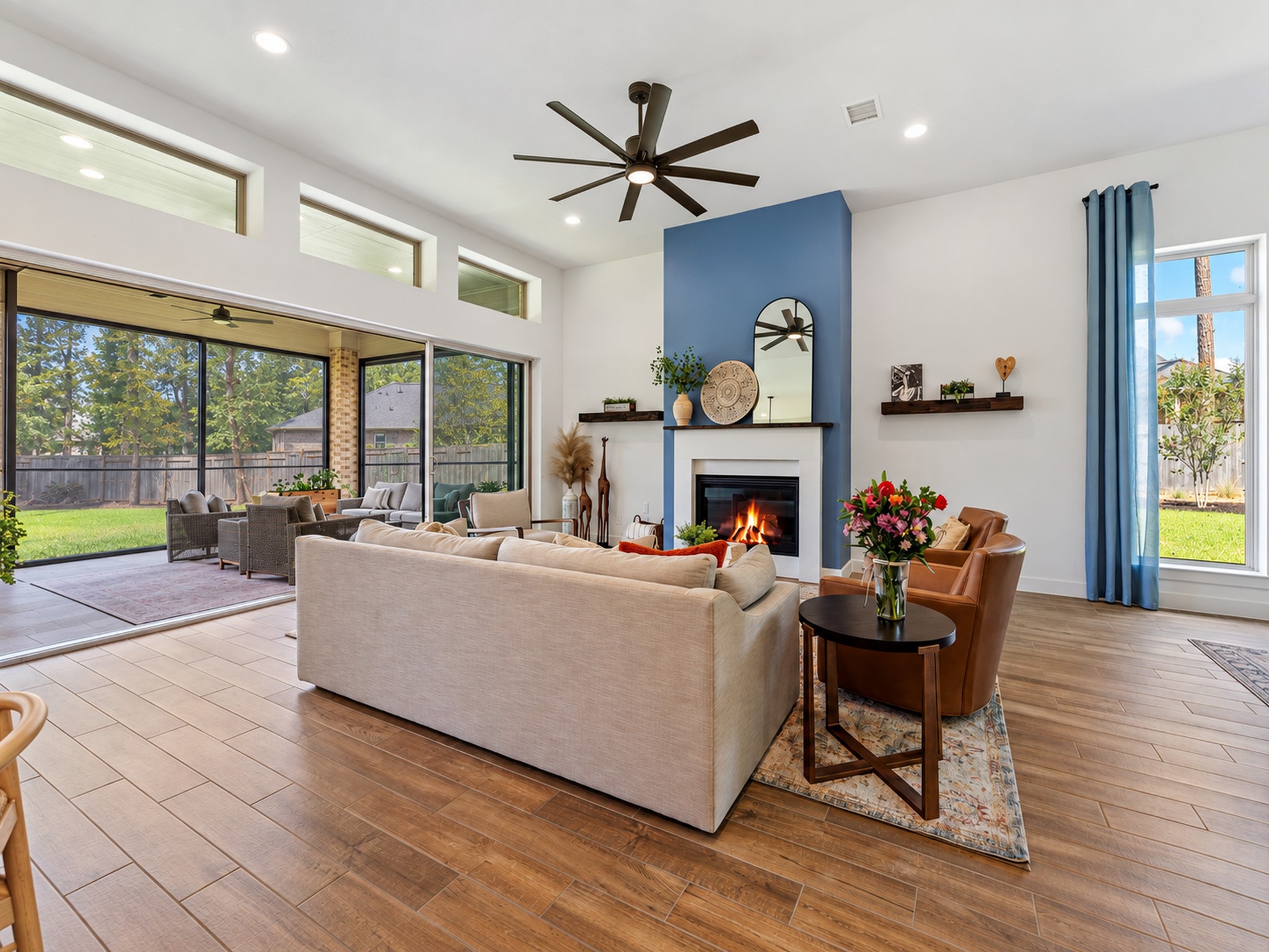 Wall of sliding doors open to extended patio complete with remote screens Wall of sliding doors open to extended patio complete with remote screens
