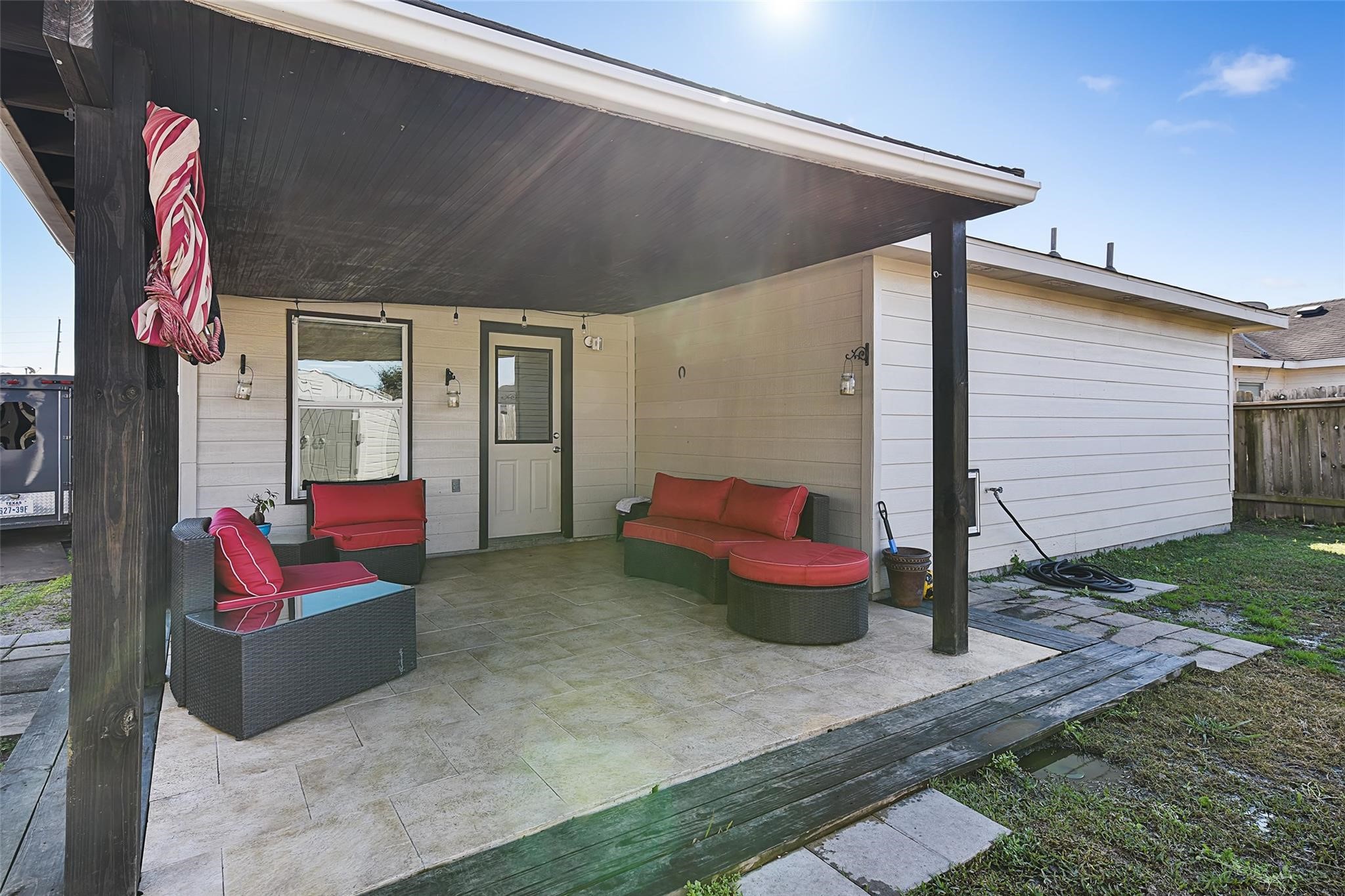 View of the covered back patio with tile