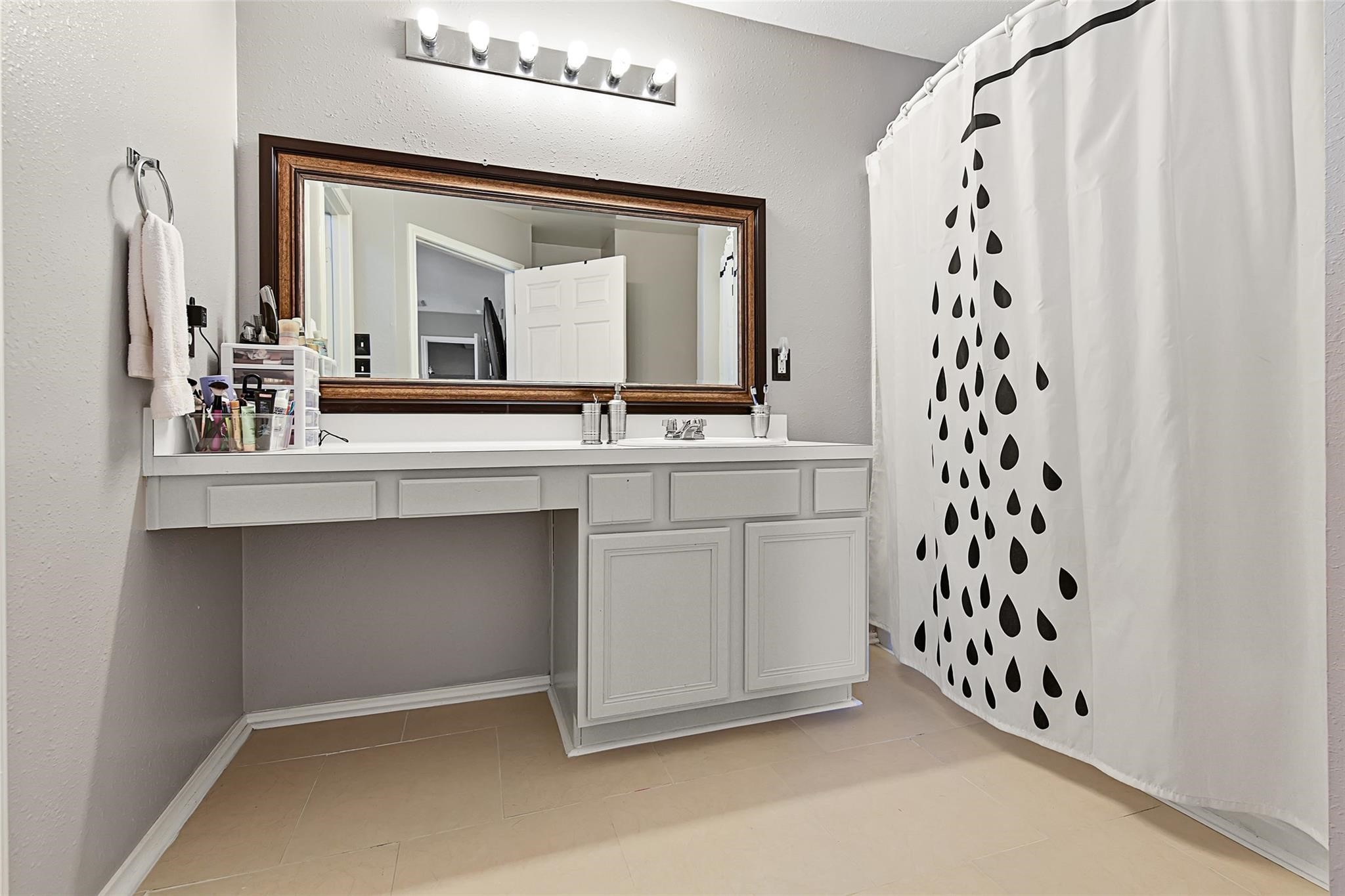 View of the primary bathroom before the recent neutral paint