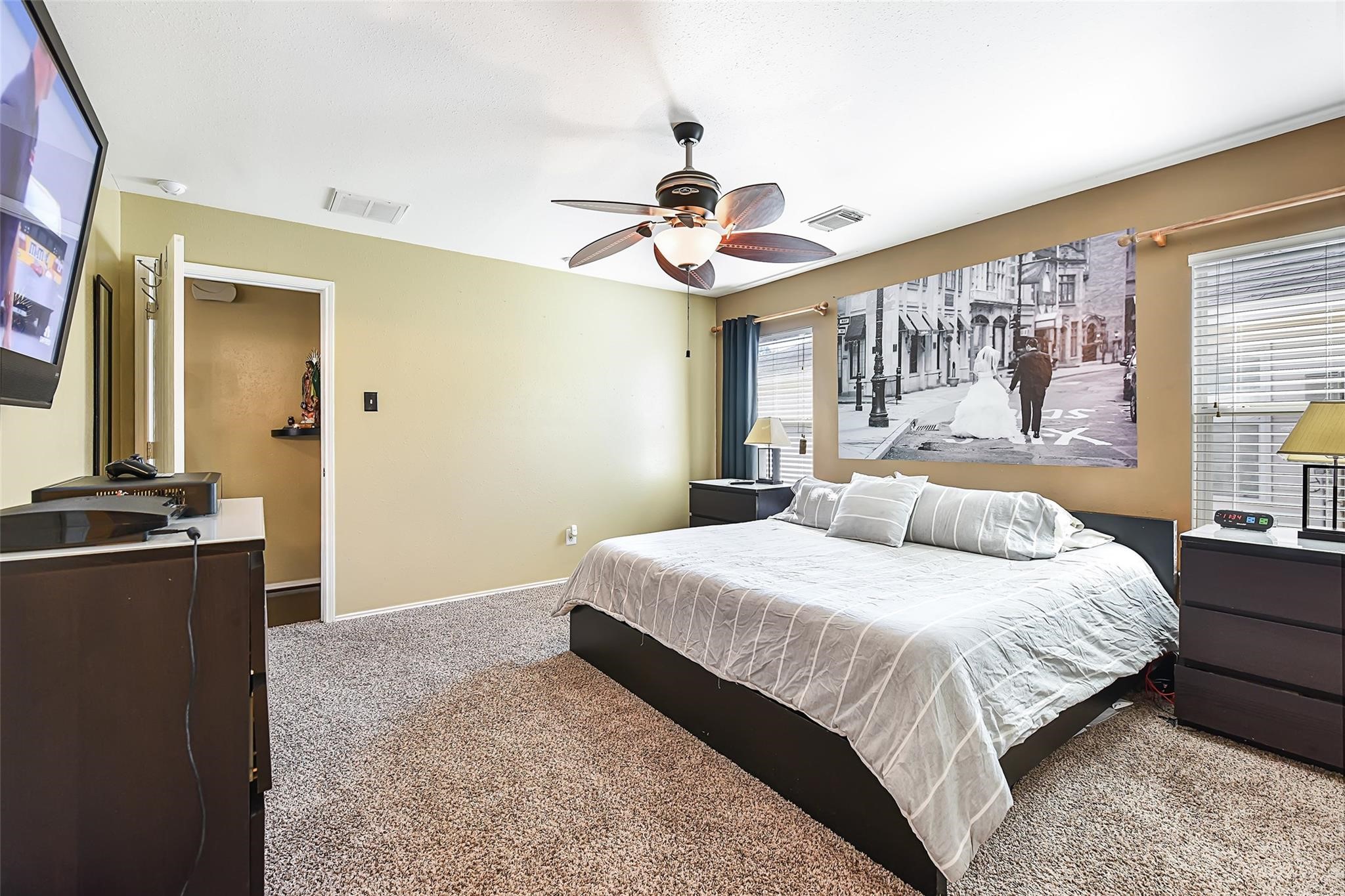 View of the primary bedroom before the recent neutral paint
