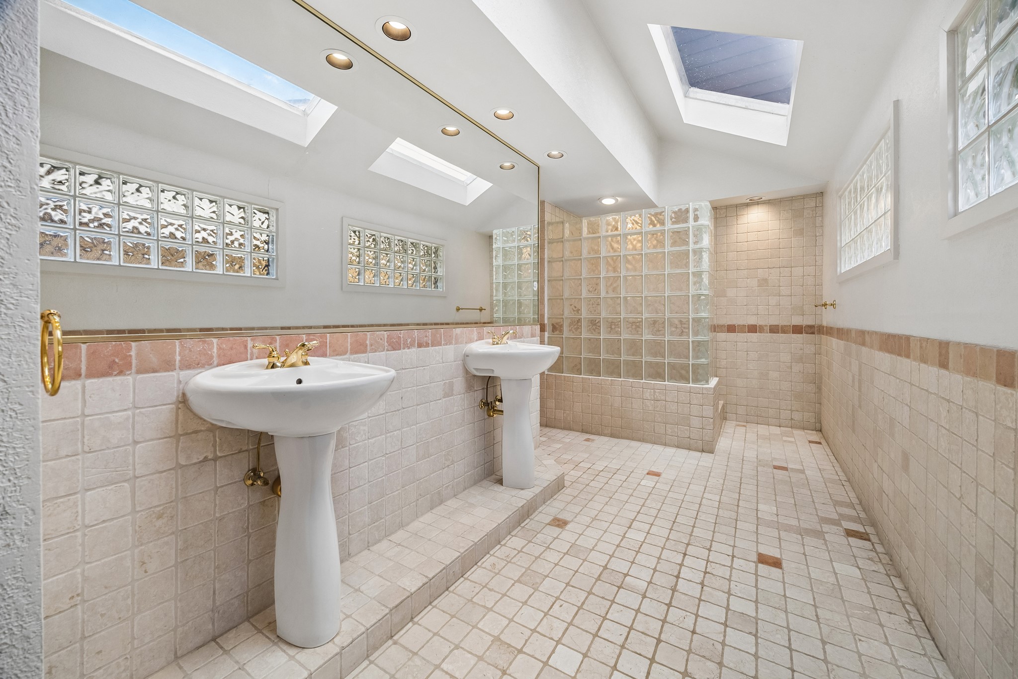 Primary bath is huge and offers double sinks, large walk in shower and off to the left is another room with water closet and storage.
