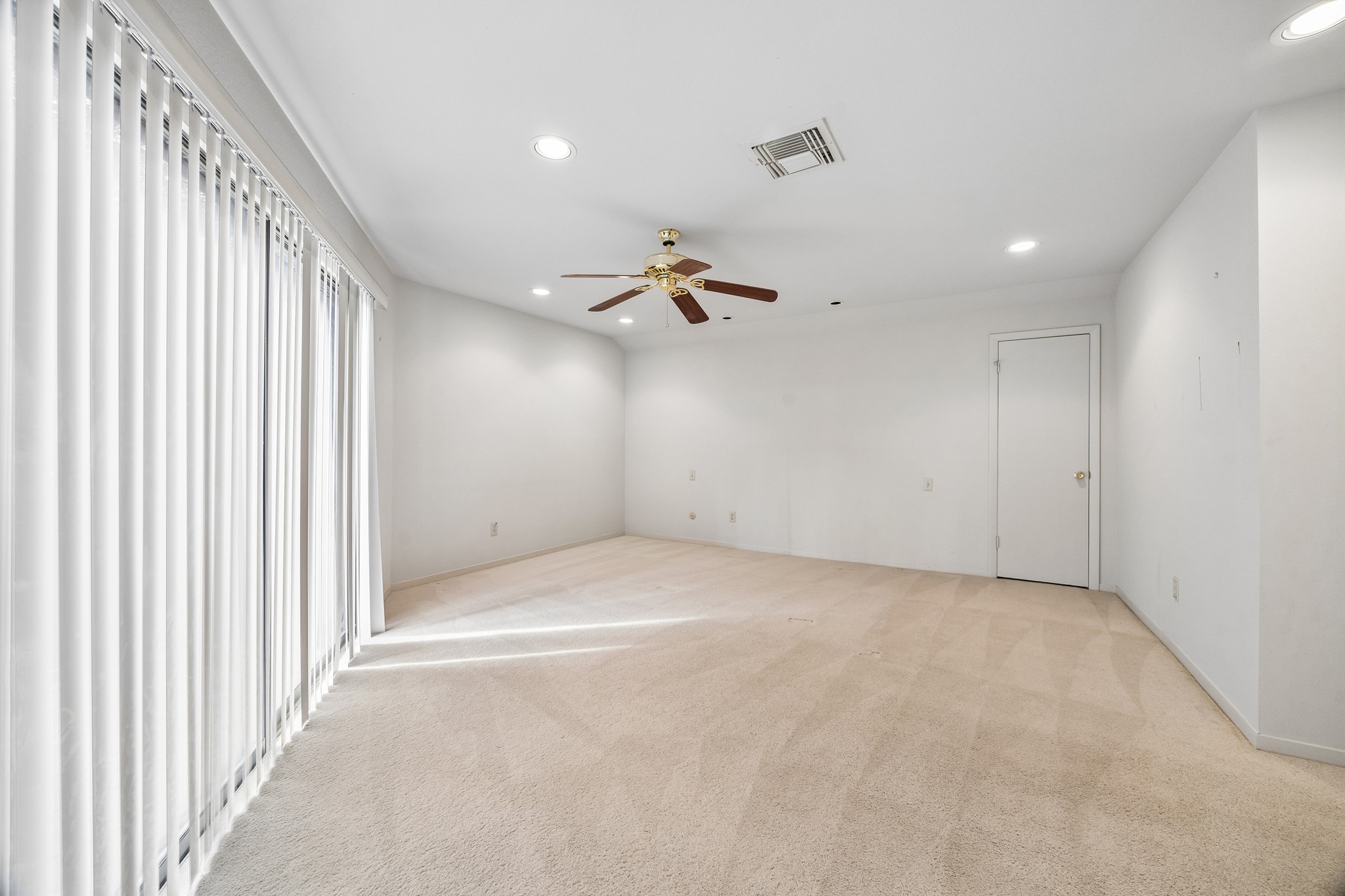 Secondary bedroom off the gameroom which features sliding doors to the second floor balcony and en-suite bath.