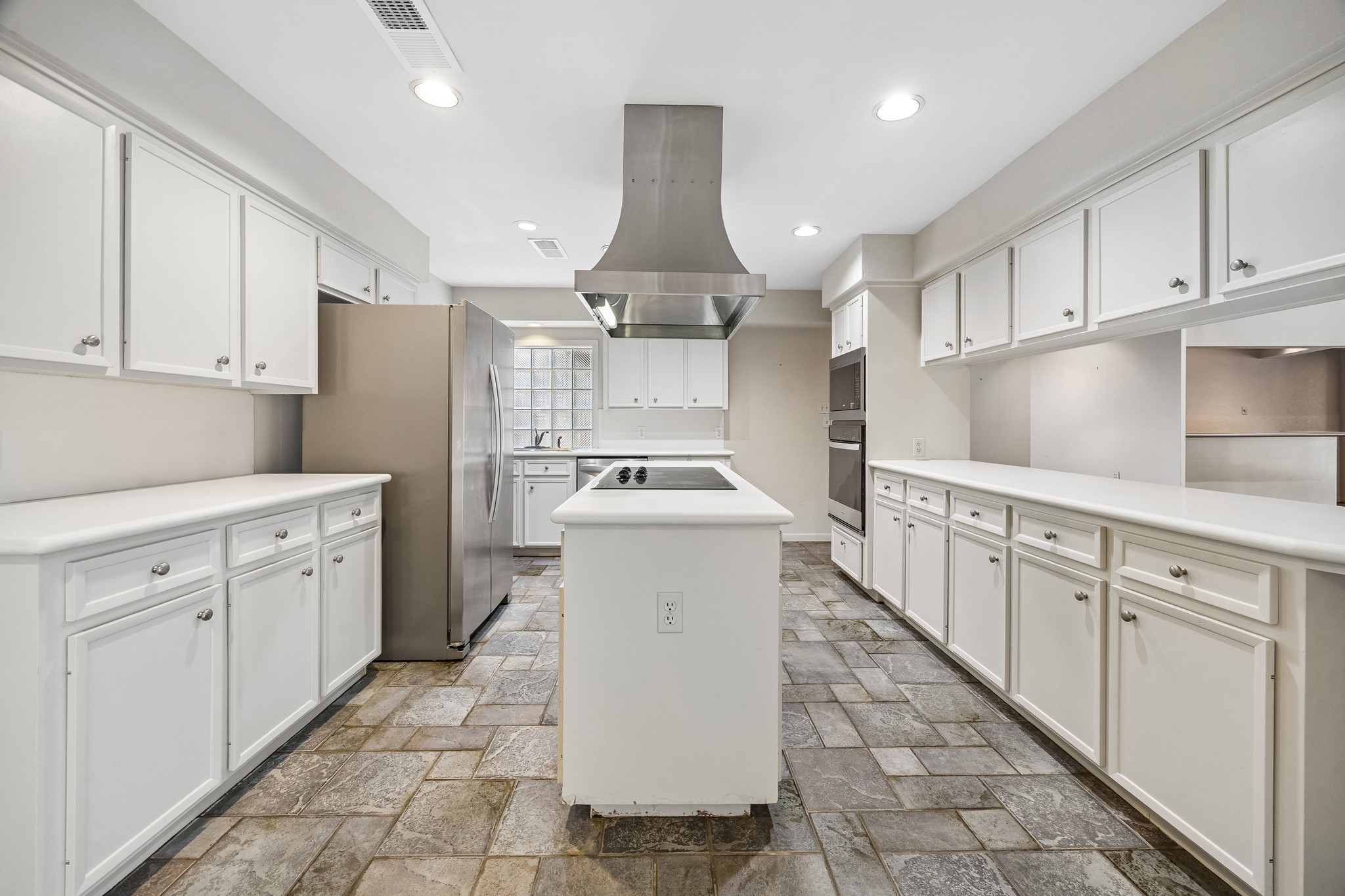 another view showcasing the abundant storage and counter tops.