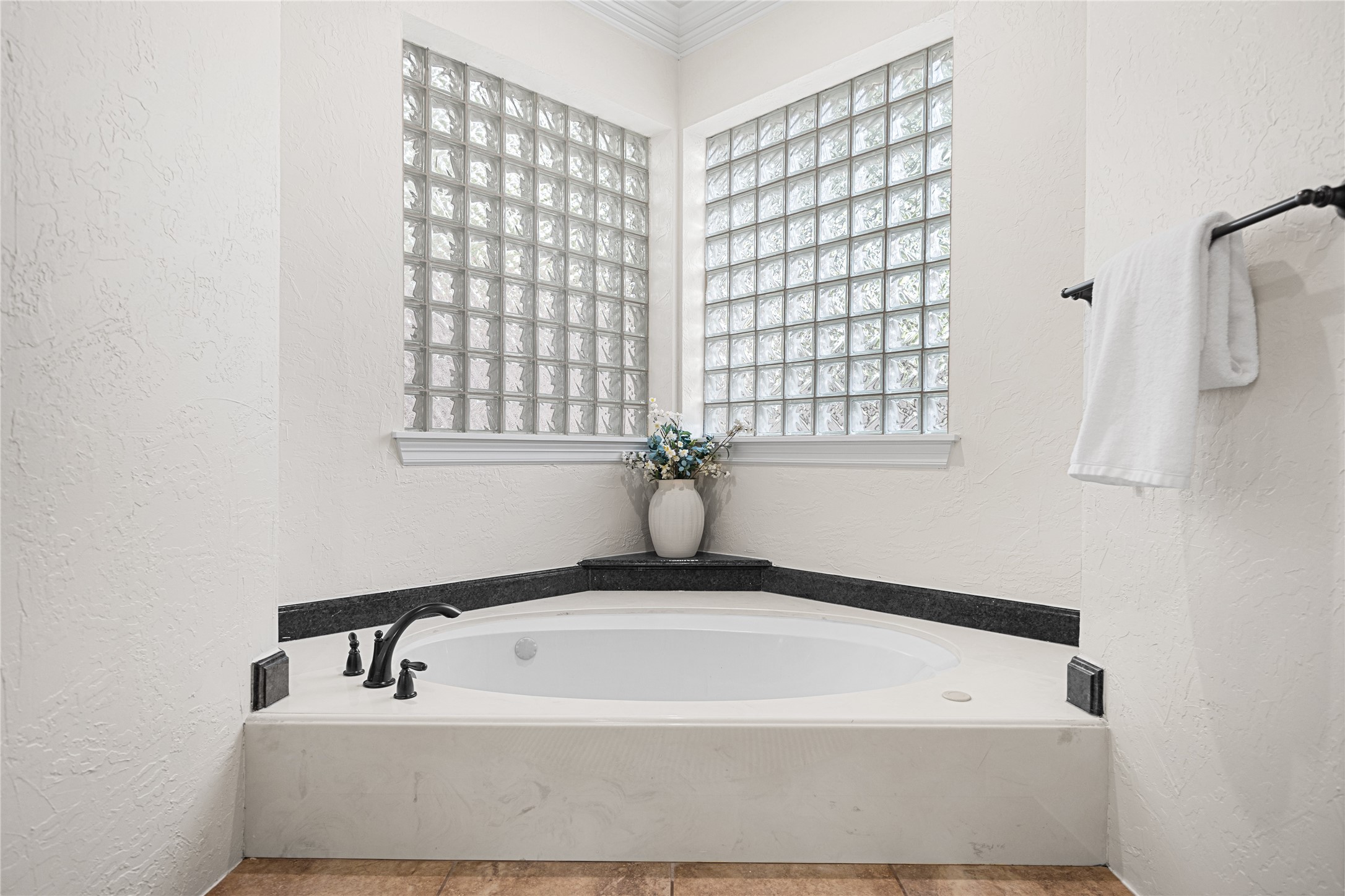 Relaxing jetted soaking tub surrounded by natural light.