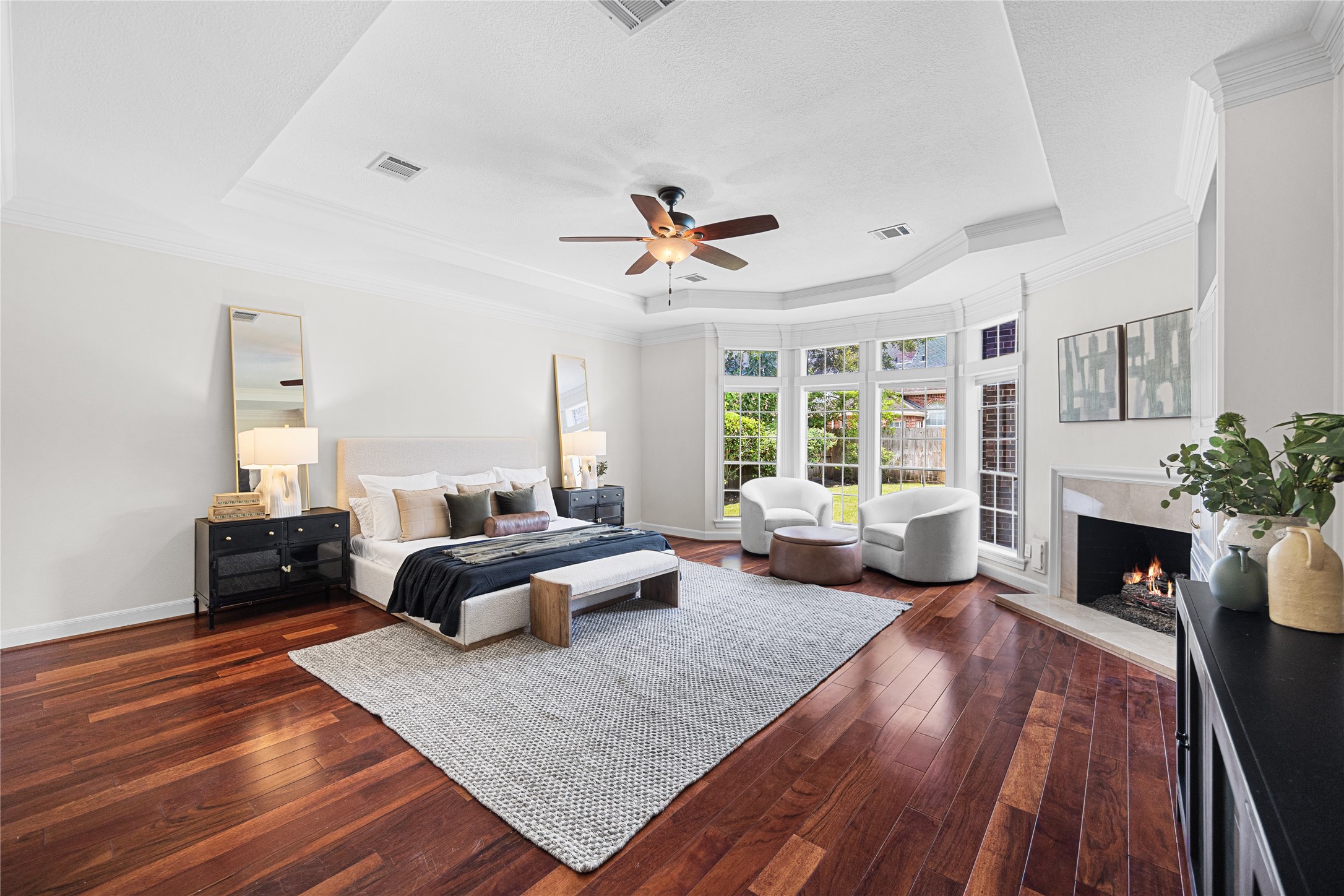 Spacious primary suite featuring a cozy fireplace and sitting area.
