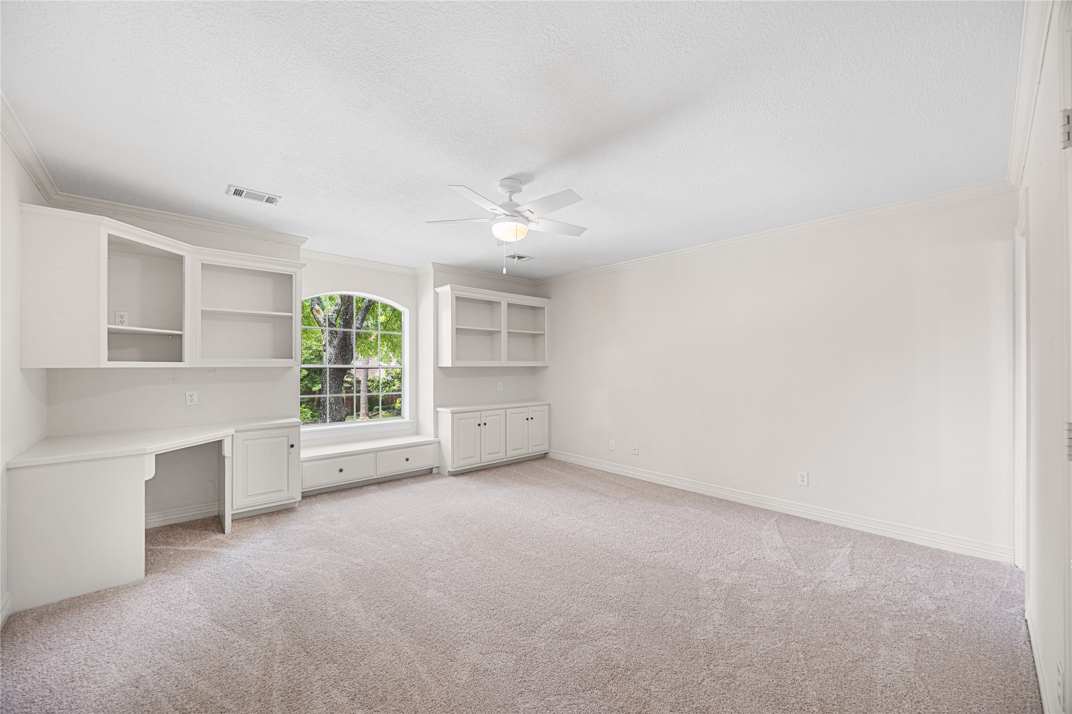 Bright secondary bedroom with custom built-ins.
