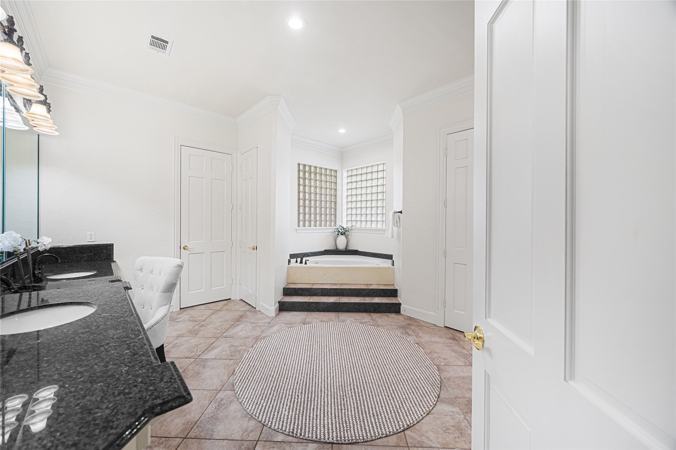 Spa-inspired primary bath with dual vanities and soaking tub.