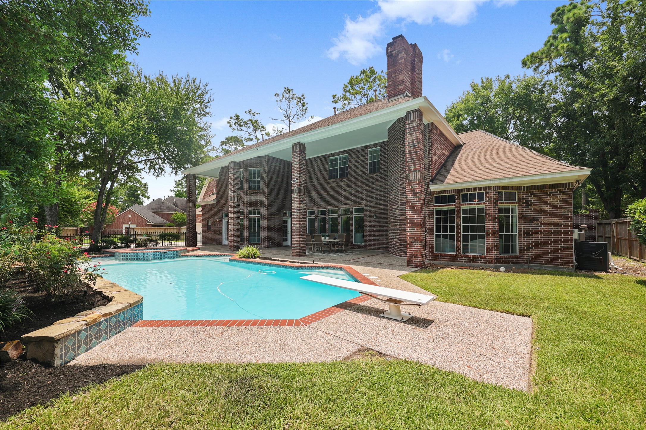 Covered outdoor living space with panoramic pool views.