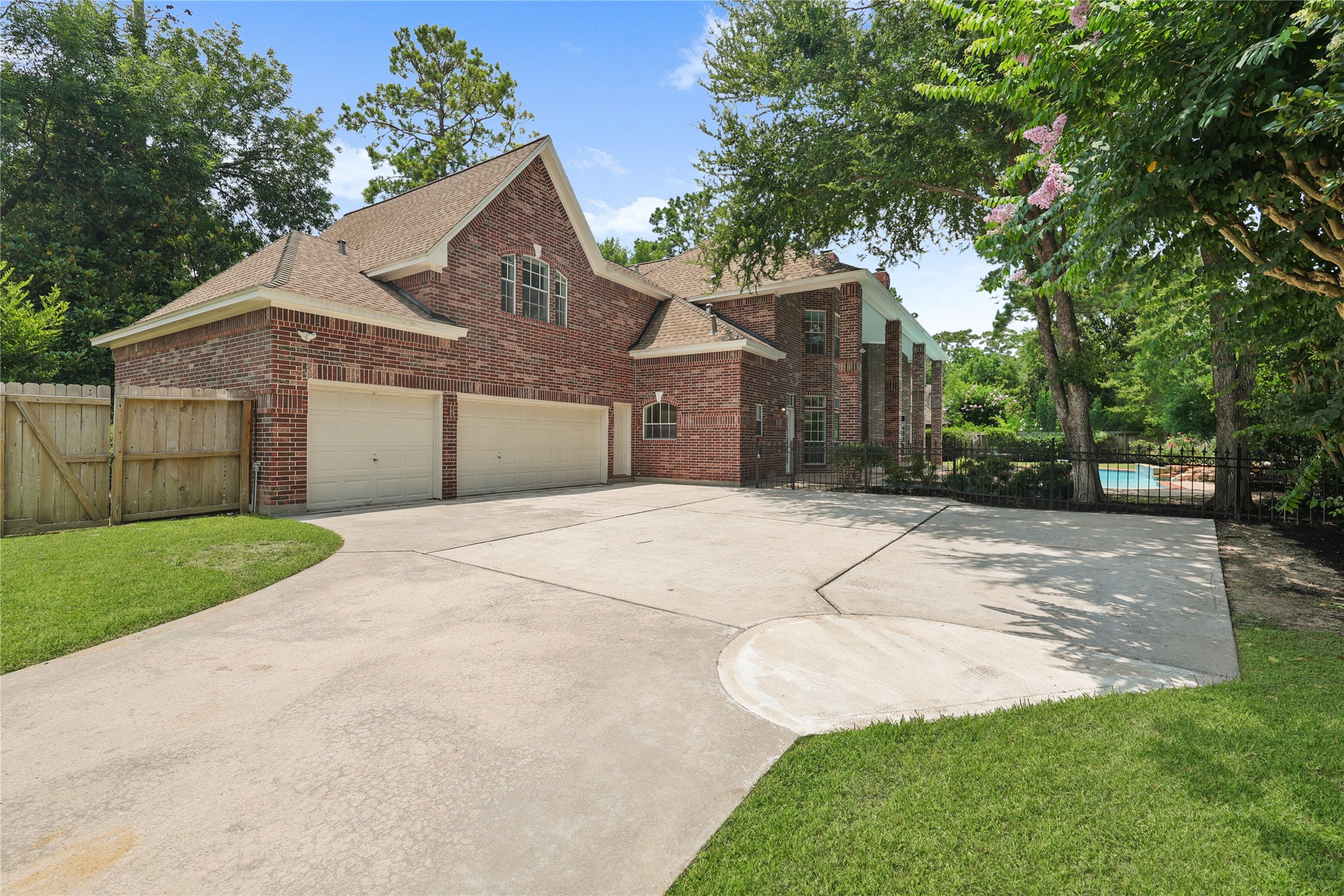 Gated driveway with oversized parking and three-car garage.