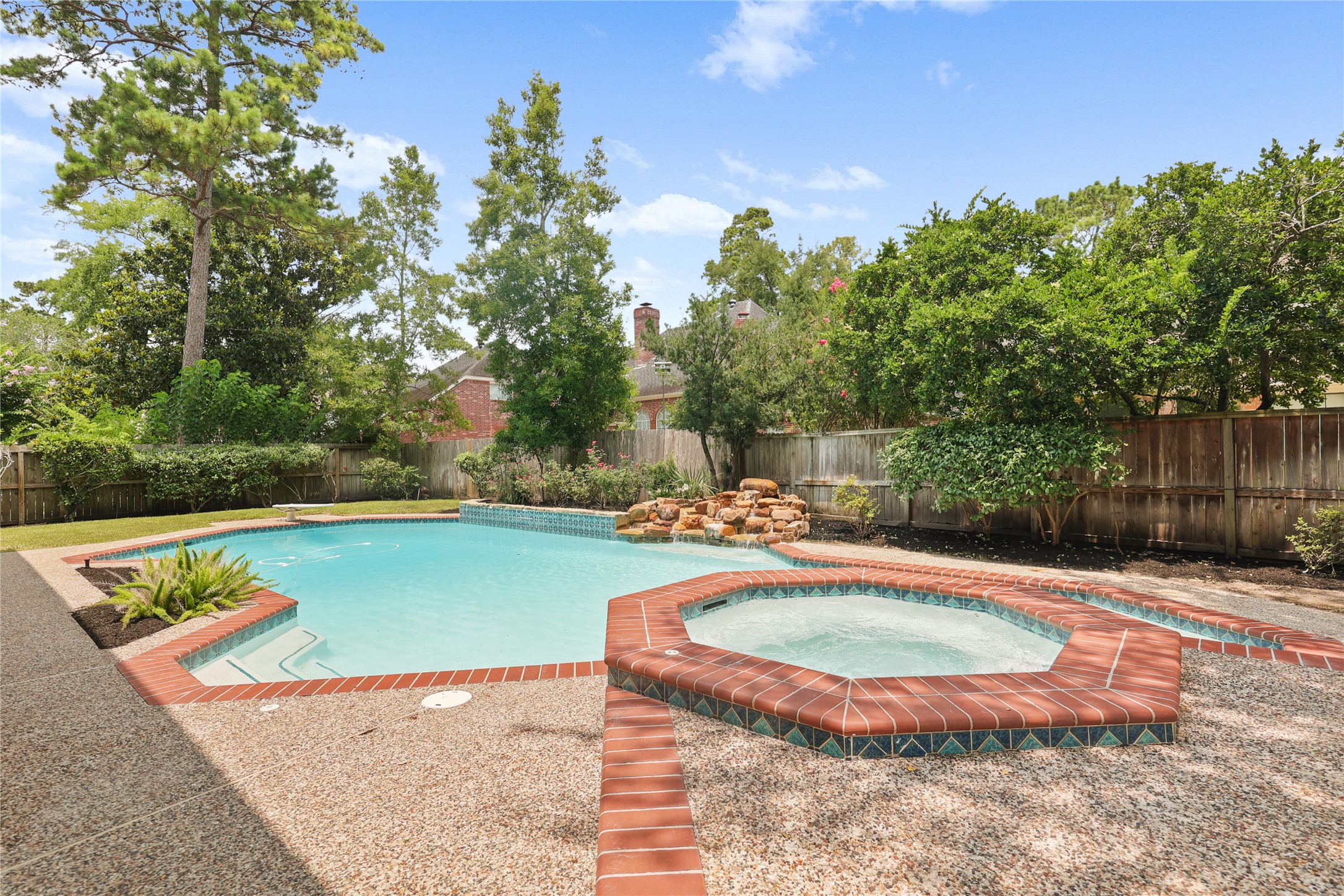 Pool and spa with peaceful rock waterfall feature.