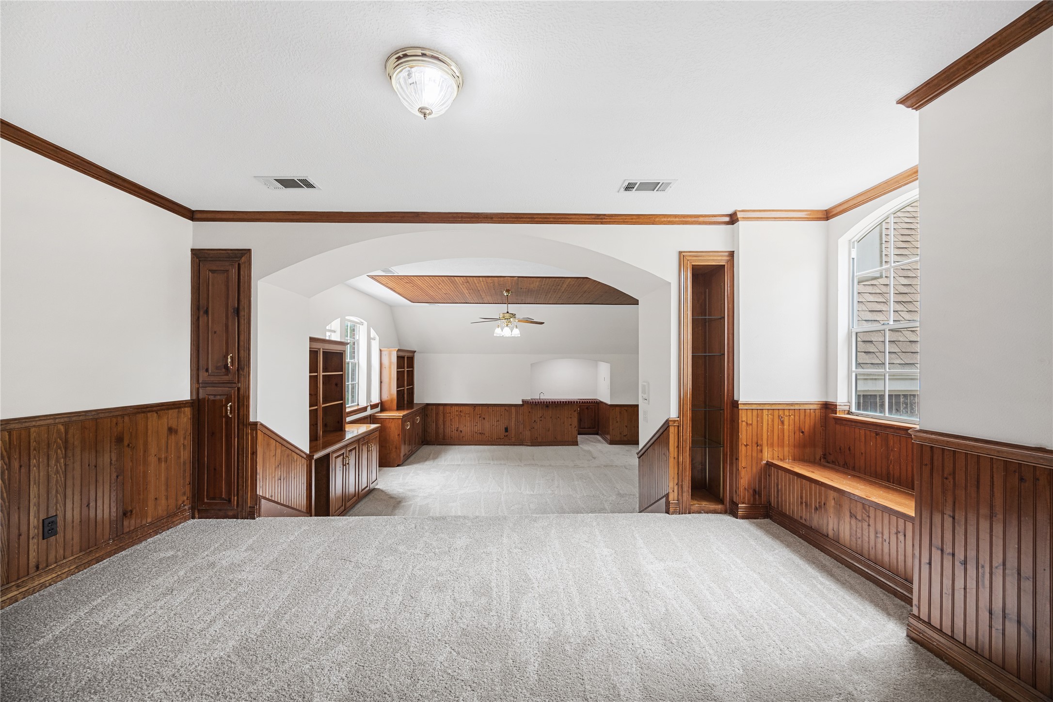 Spacious game room with custom woodwork and endless possibilities.
