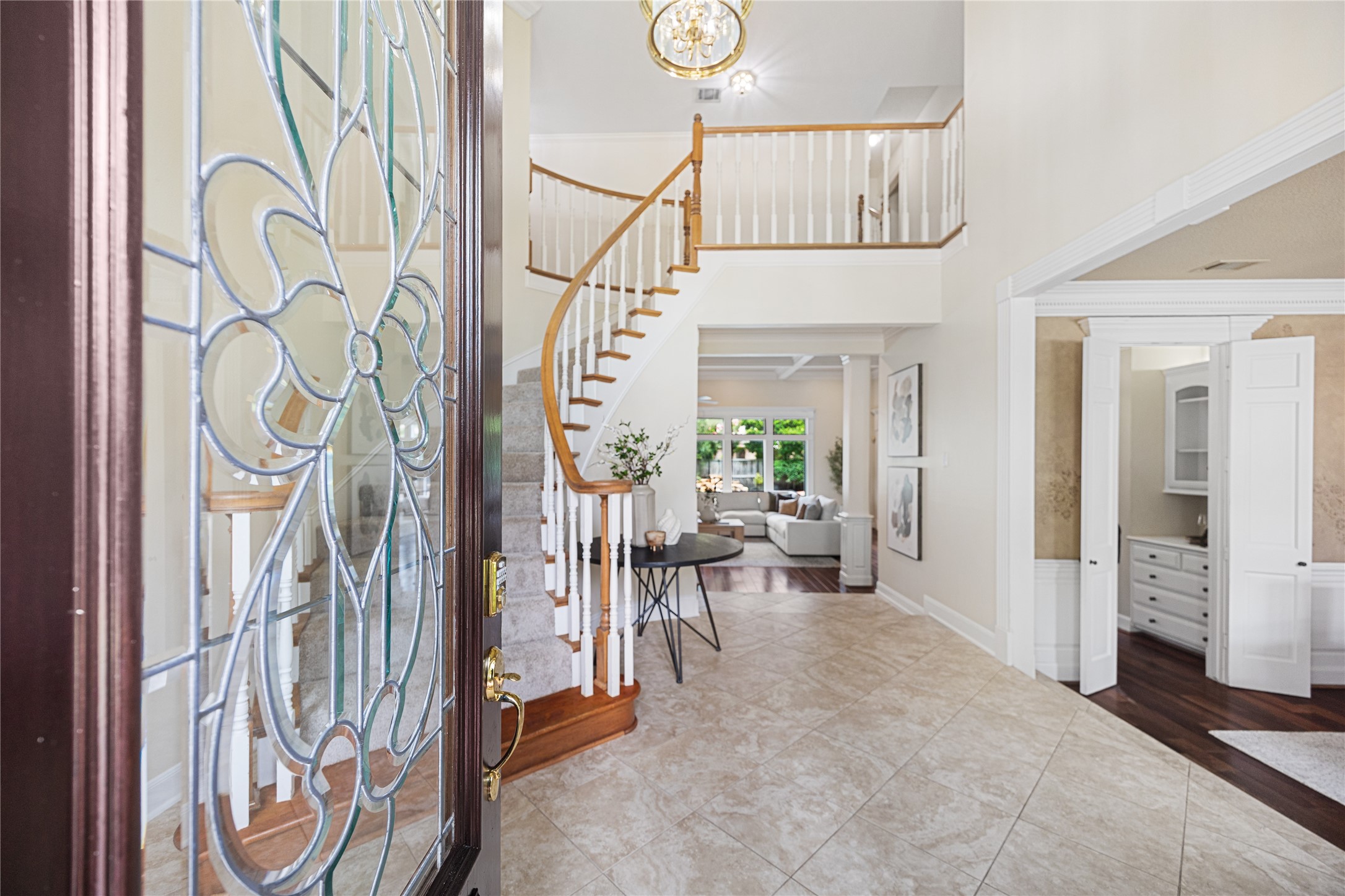 Elegant front entry with soaring ceilings and sweeping staircase. Elegant front entry with soaring ceilings and sweeping staircase.