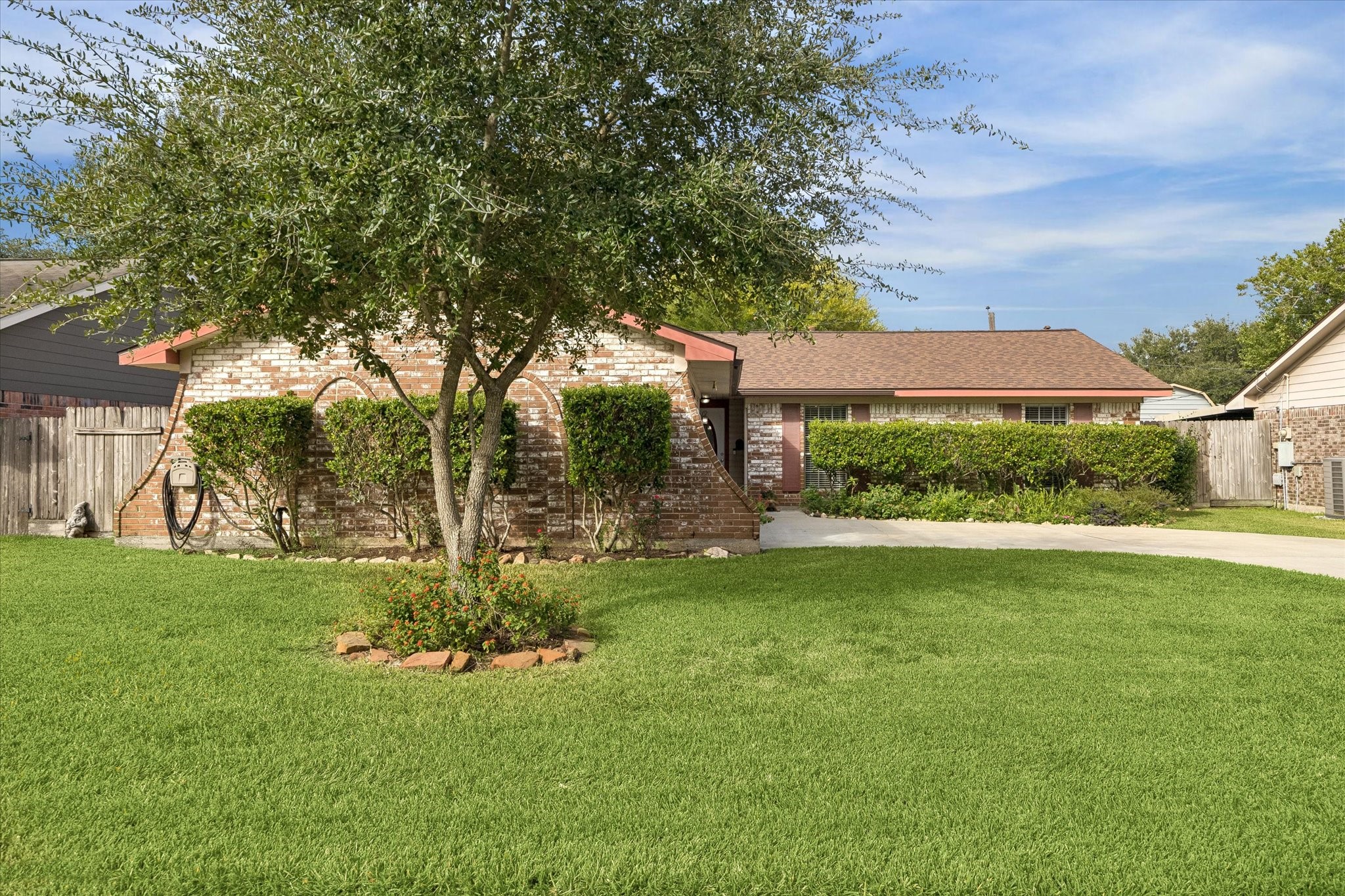 Beautiful brick home featuring a welcoming front yard, a large established tree, and well-maintained landscaping. Its timeless brick exterior and inviting curb appeal create a warm and welcoming first impression.