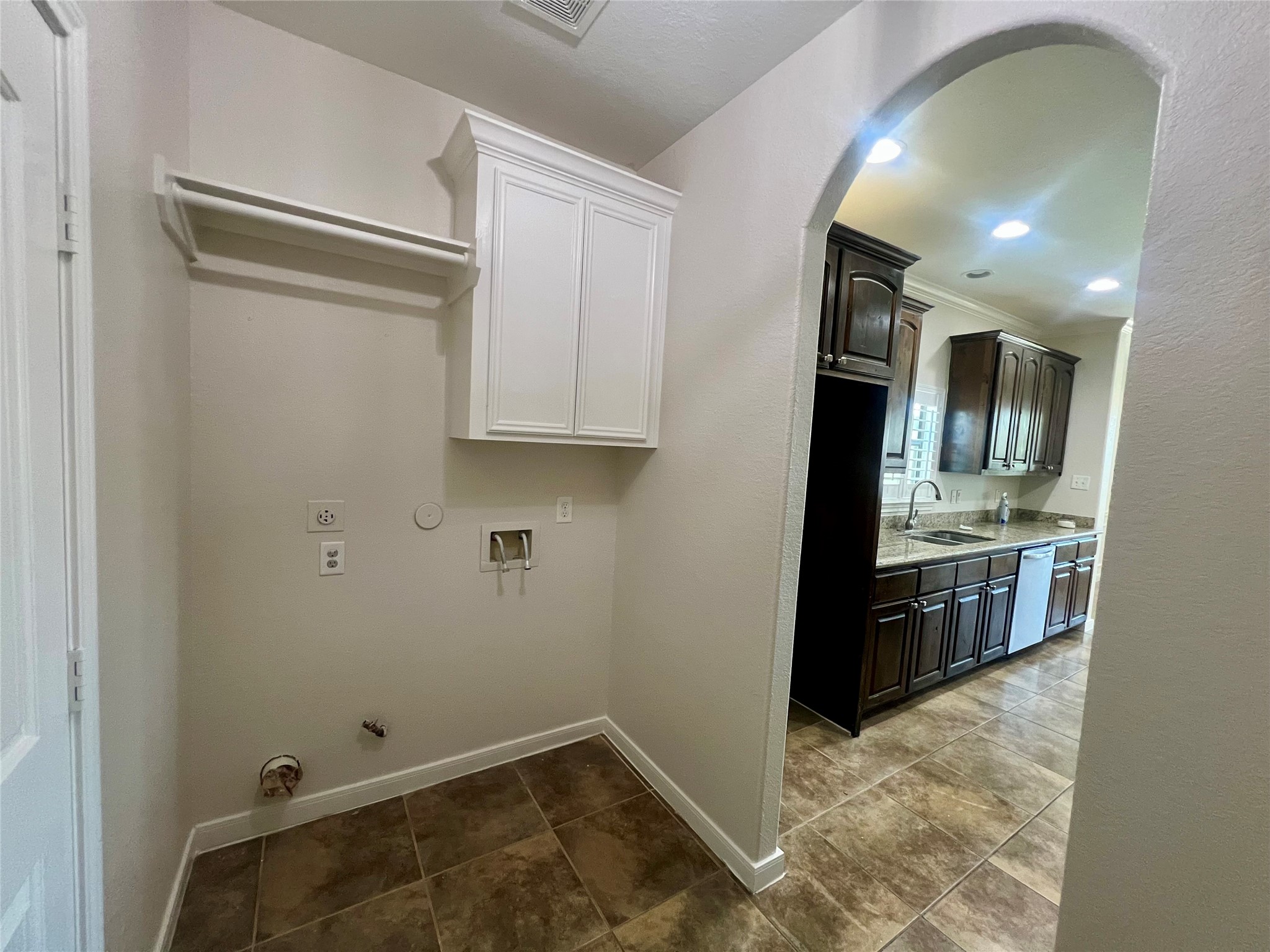 Laundry room conveniently located off kitchen.