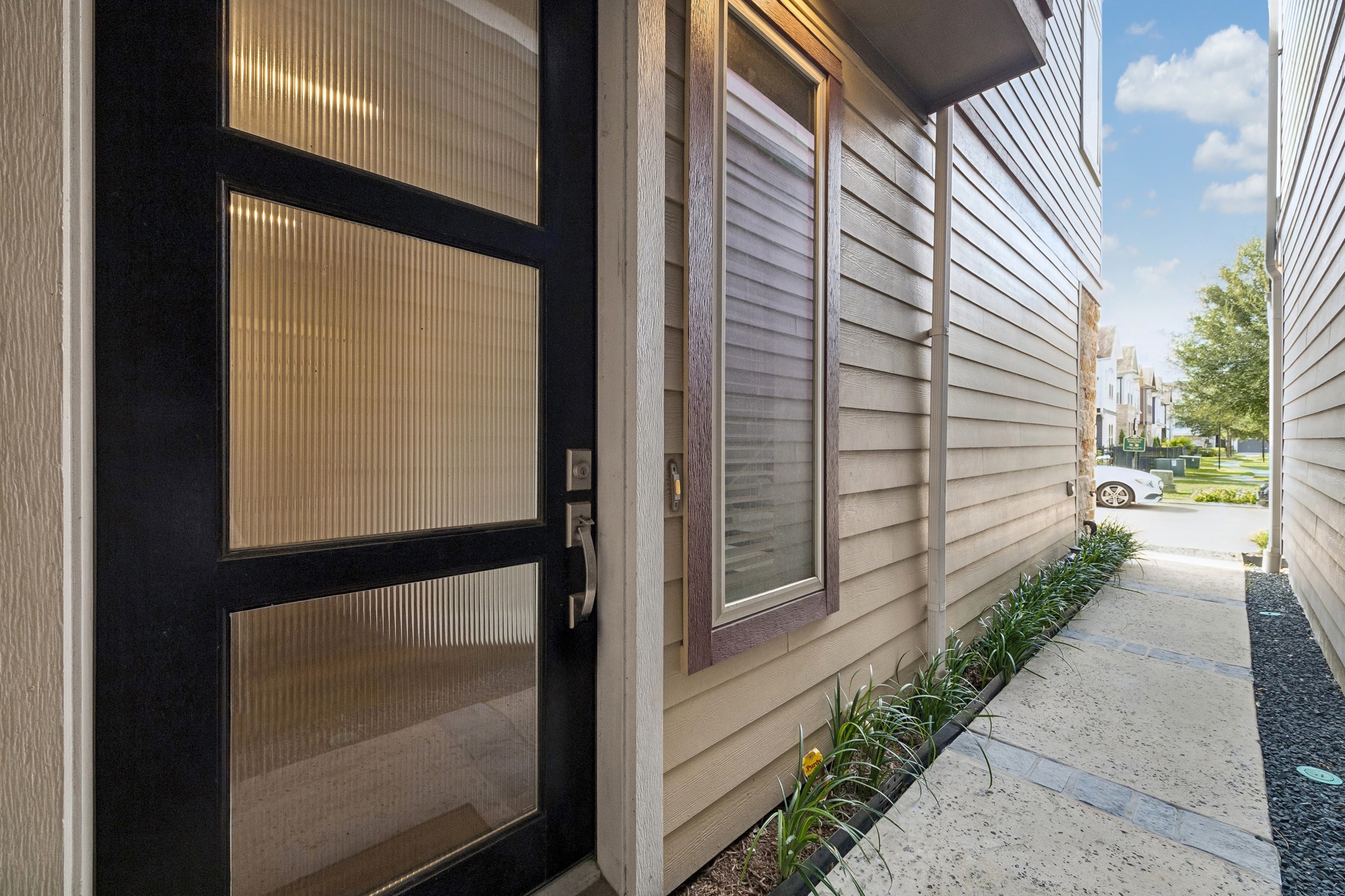 A beautiful private walkway guides you to the home's inviting front entrance, offering privacy.