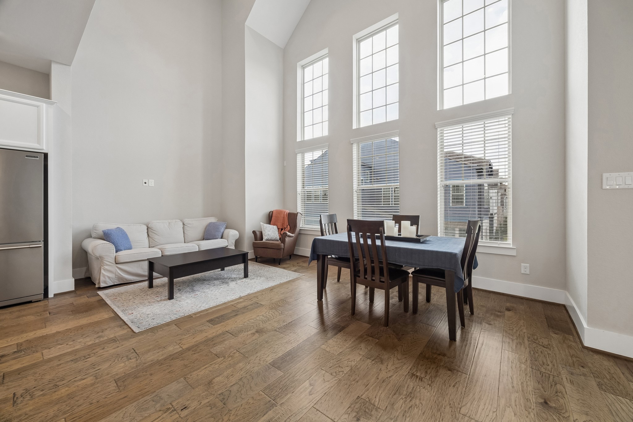 The main living area features soaring ceilings and beautiful engineered wood flooring, creating an open and inviting atmosphere.