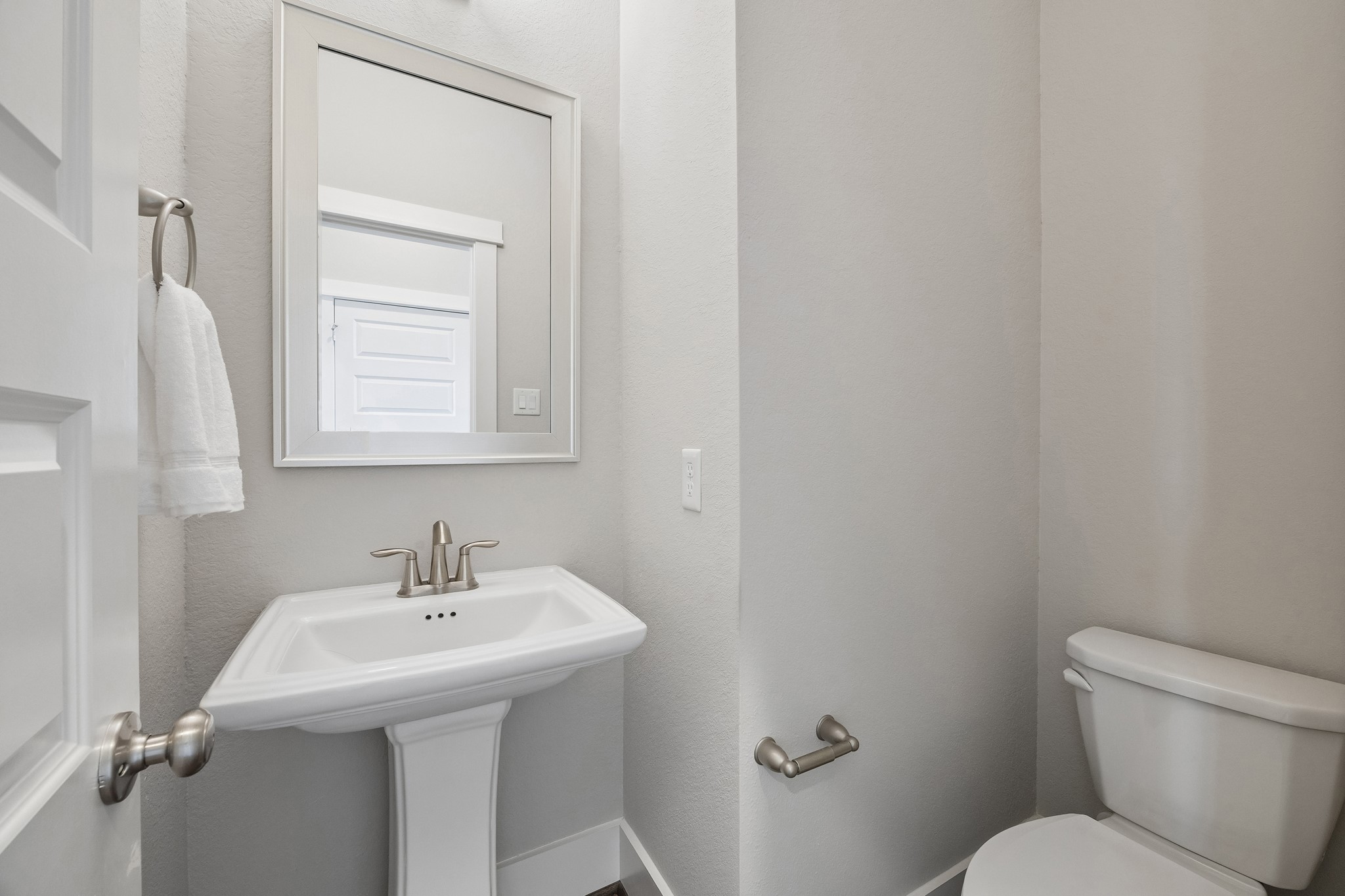 A well-appointed powder bath offers both style and convenience for guests.