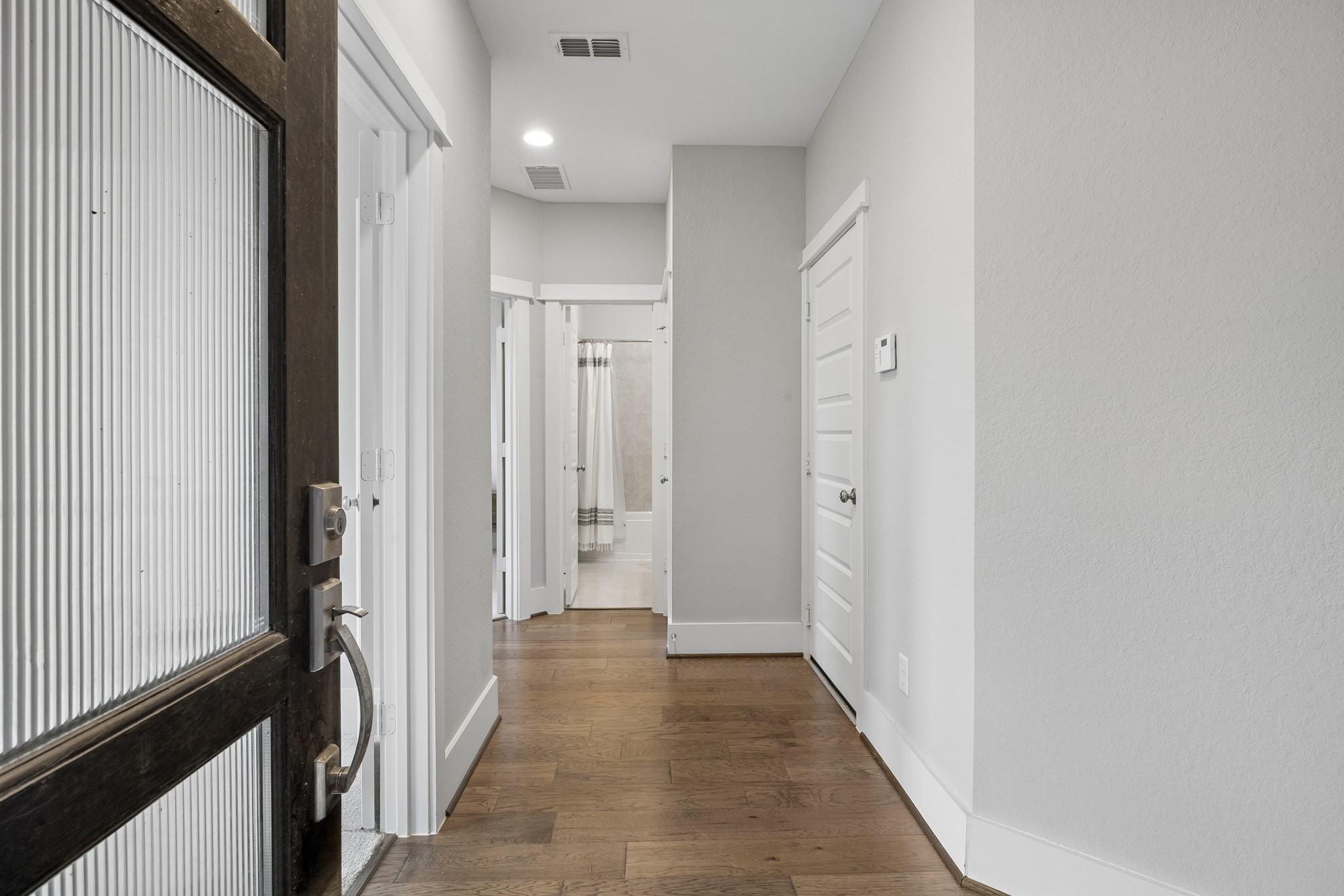Upon entering the home, you're welcomed by a bright and inviting entryway enhanced by beautiful engineered wood flooring.