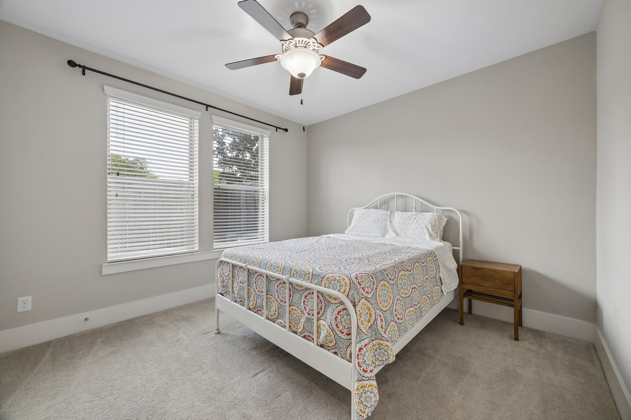 This is the second downstairs bedroom, offering the flexibility to serve as a guest room, home office, or private workspace.