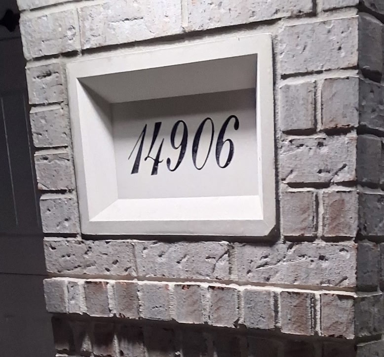 Charming brick entryway with a stylishly recessed address plaque.