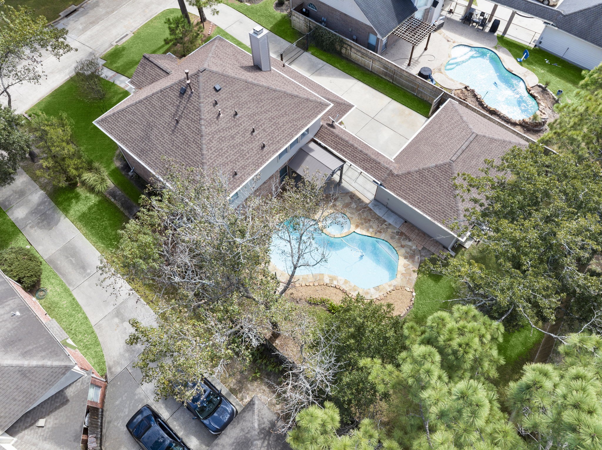 A BIRD'S-EYE VIEW OF PARADISE! Take in the beautiful newer roof, canopy of mature shade trees, and generous lot! A gated driveway leads to the detached 3-car garage, offering added privacy and plenty of parking. The sparkling freeform pool and spa, flagstone decking, and covered outdoor entertaining area complete this backyard oasis. SO MUCH TO LOVE FROM EVERY ANGLE!